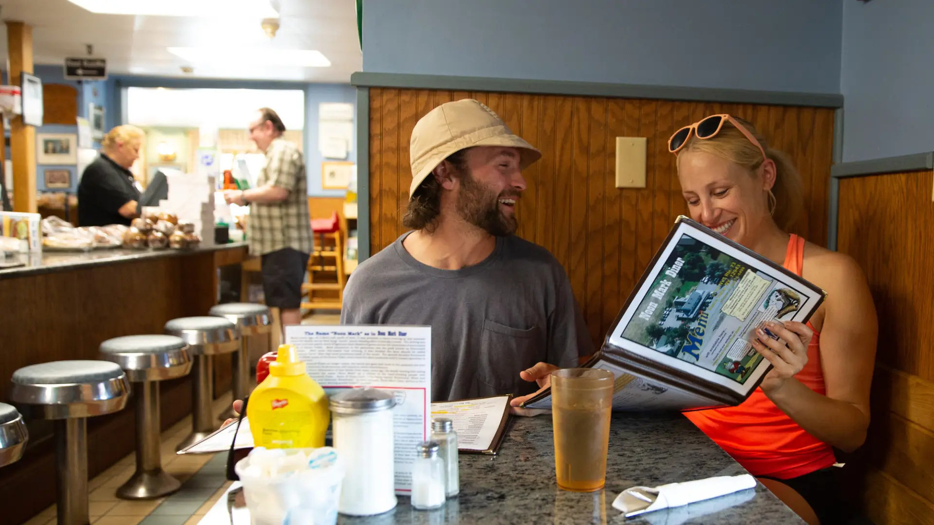 Two people look at diner menu