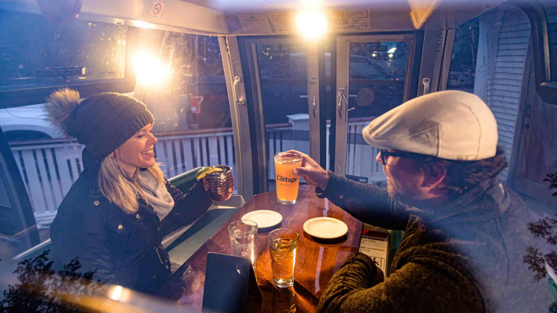 Man and woman inside gondola eating dinner