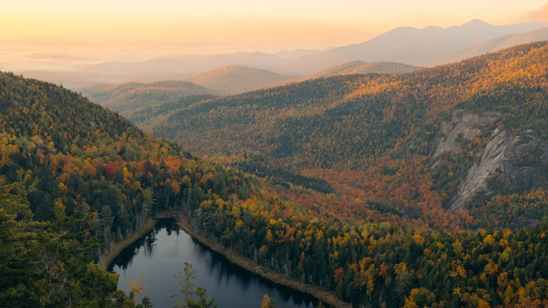 A large lake nestled high in the mountains during the fall