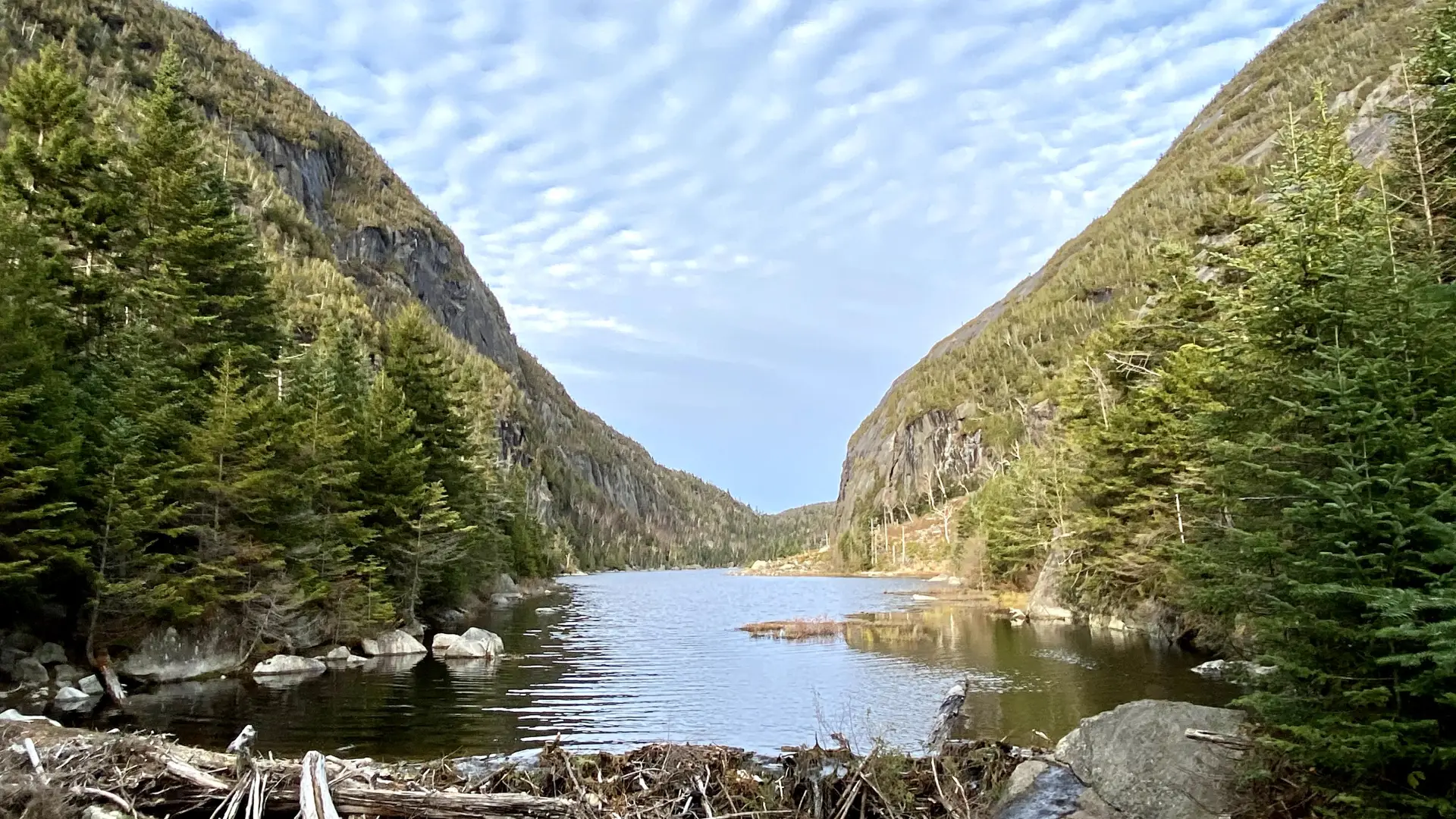 A narrow lake surround by mountains