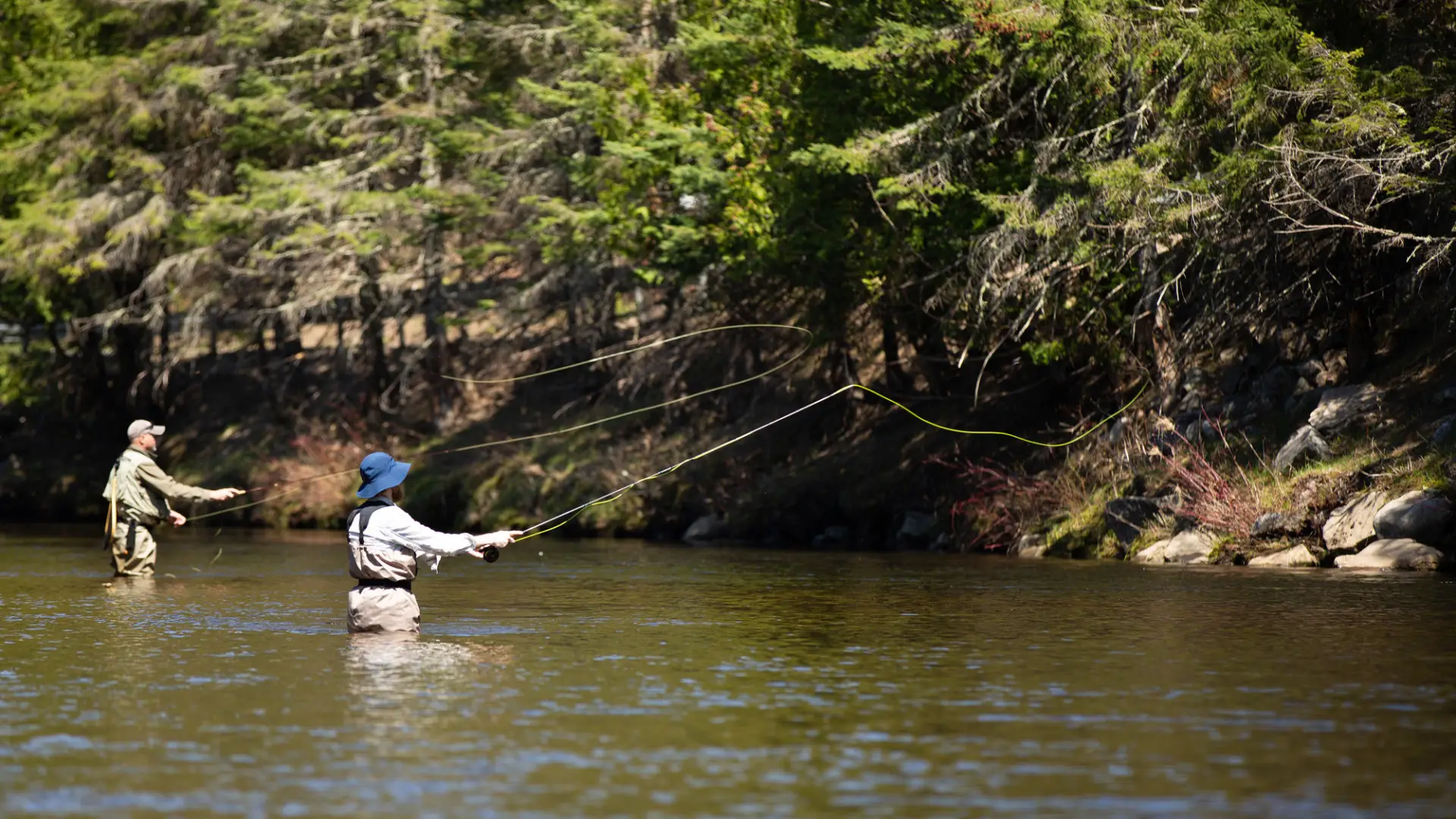 Two anglers waded into river fly fishing
