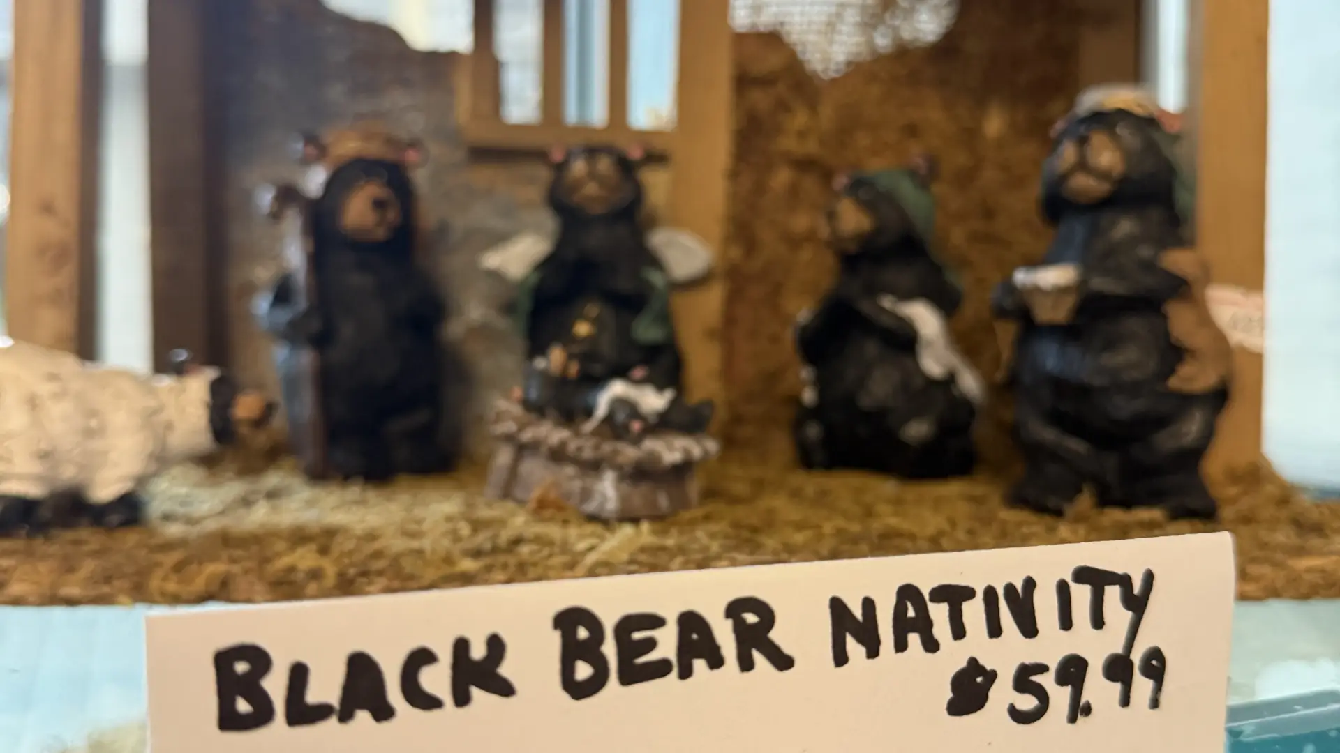 A rustic nativity scene featuring black bears in the stable.