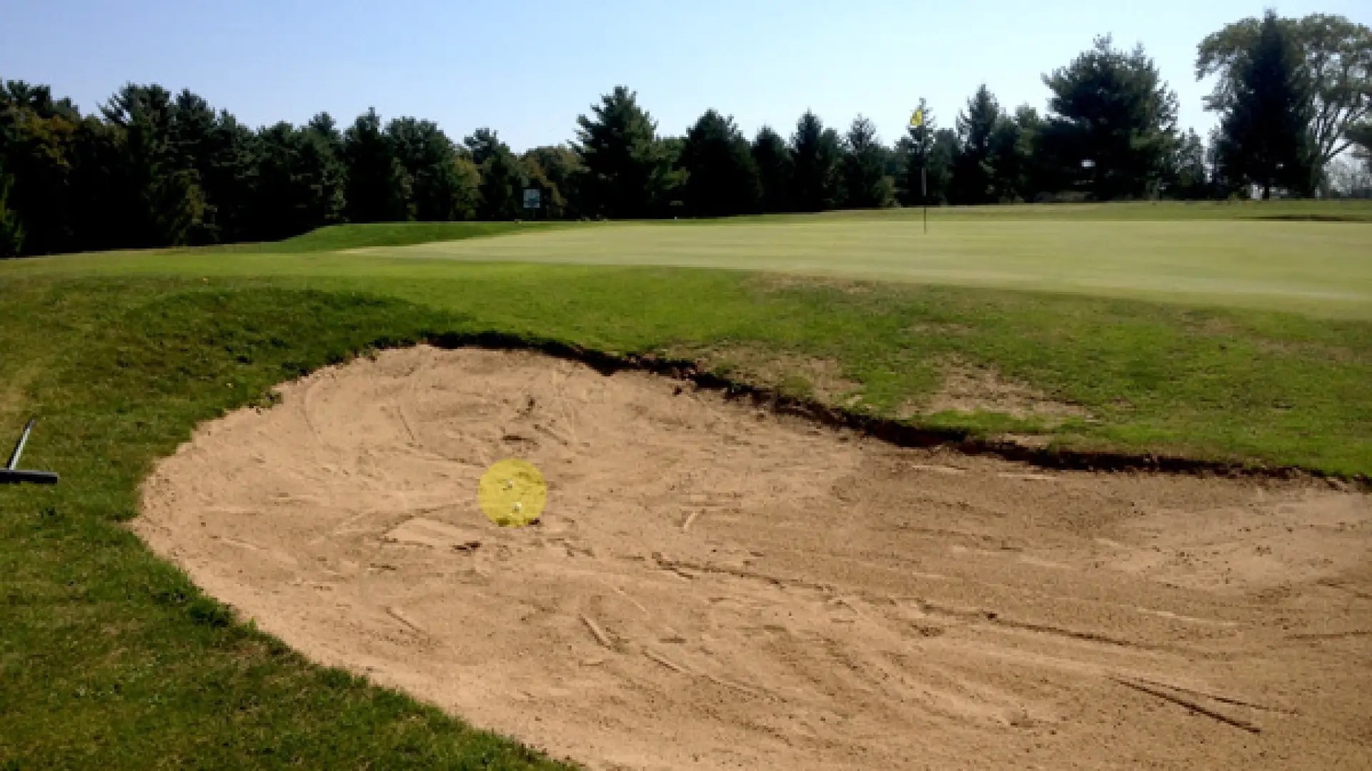TWO balls in the sand trap at the Westport Country Club