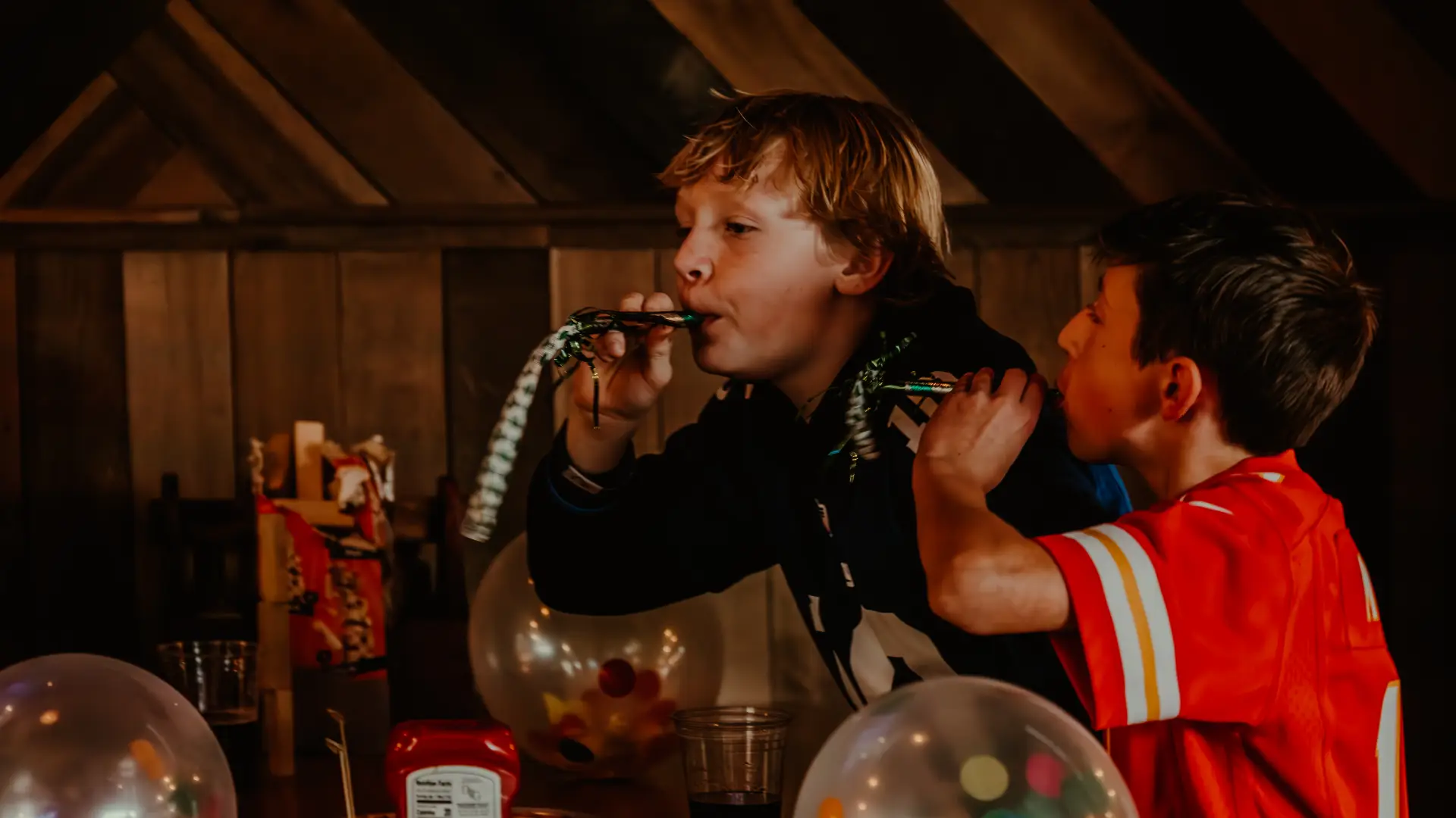 Balloons filled with colorful confetti and kids with noise maker party favors.  Photo Credit to A. Kelly.
