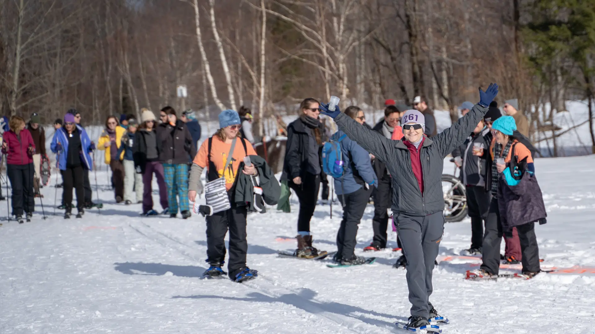 Snowshoers and cross-country skiers on a trail. 