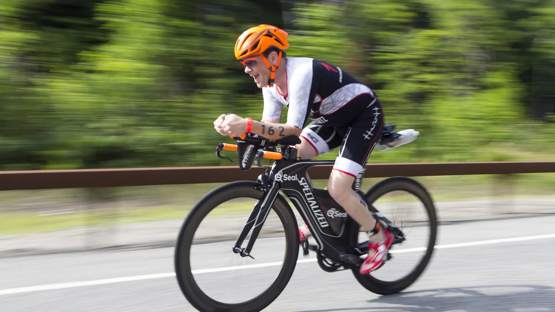 A biker speeds by on a road.
