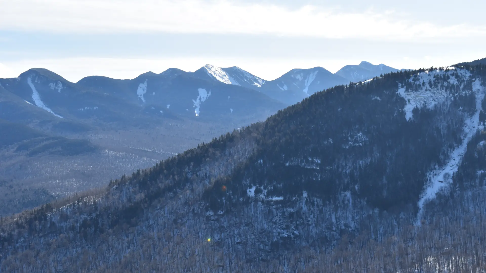 The view of mountains lightly covered in snow