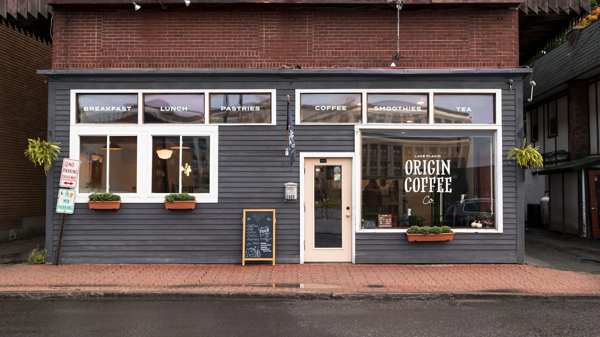 The blue and white exterior of Origin Coffee in Lake Placid