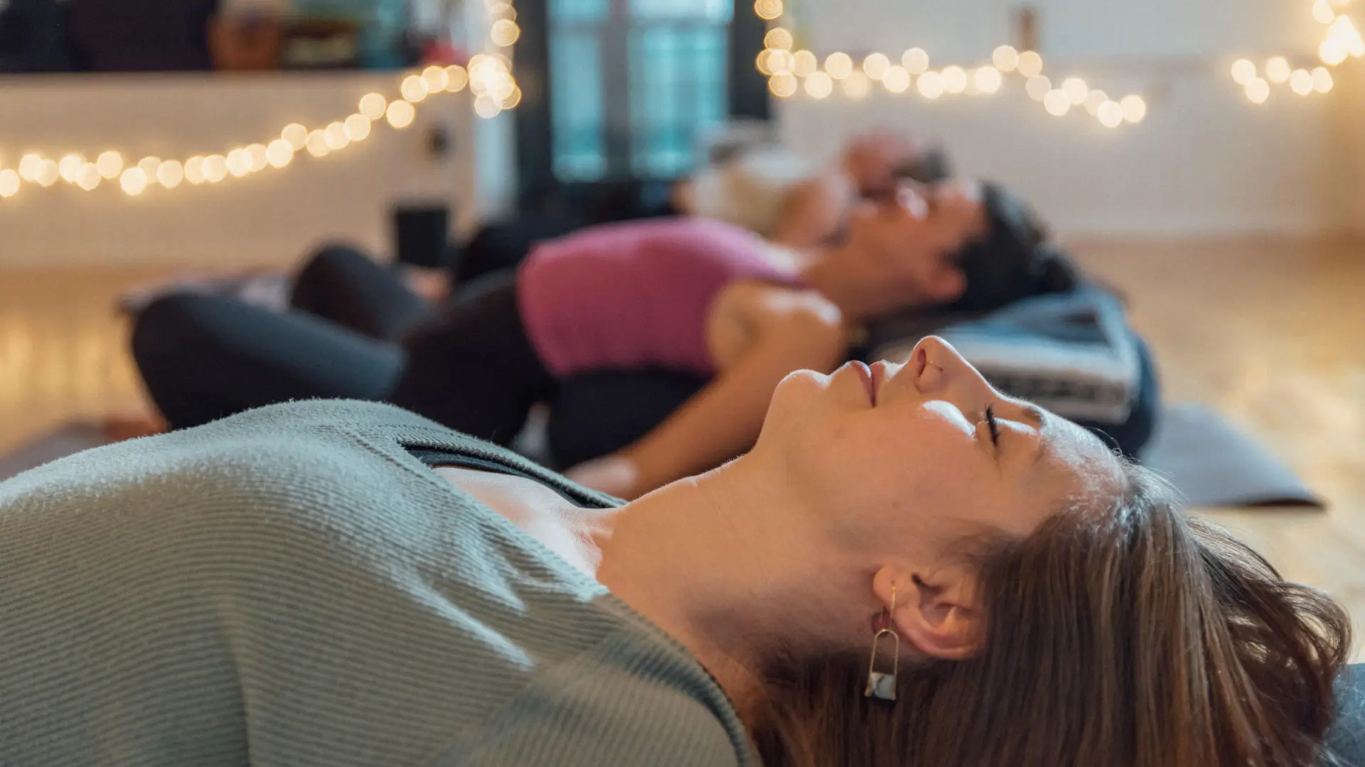 People laying in Savasana after their practice
