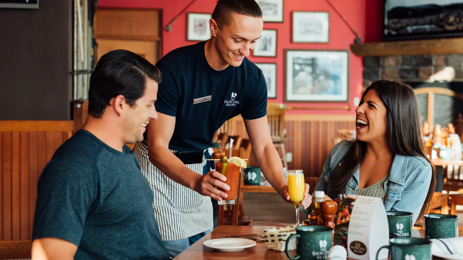 A man and woman order food at a cozy restaurant.