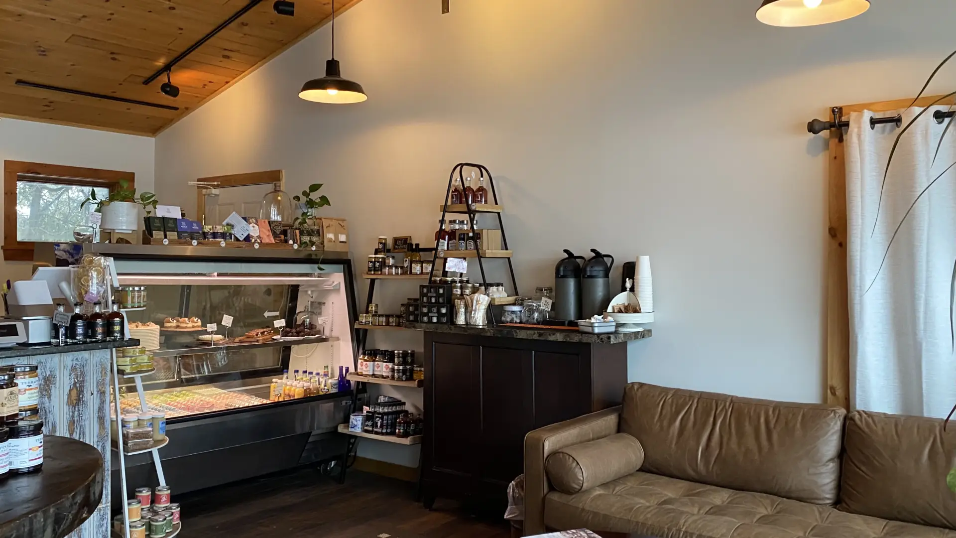 The casual couch-seating area and pastry shelf at Enuf