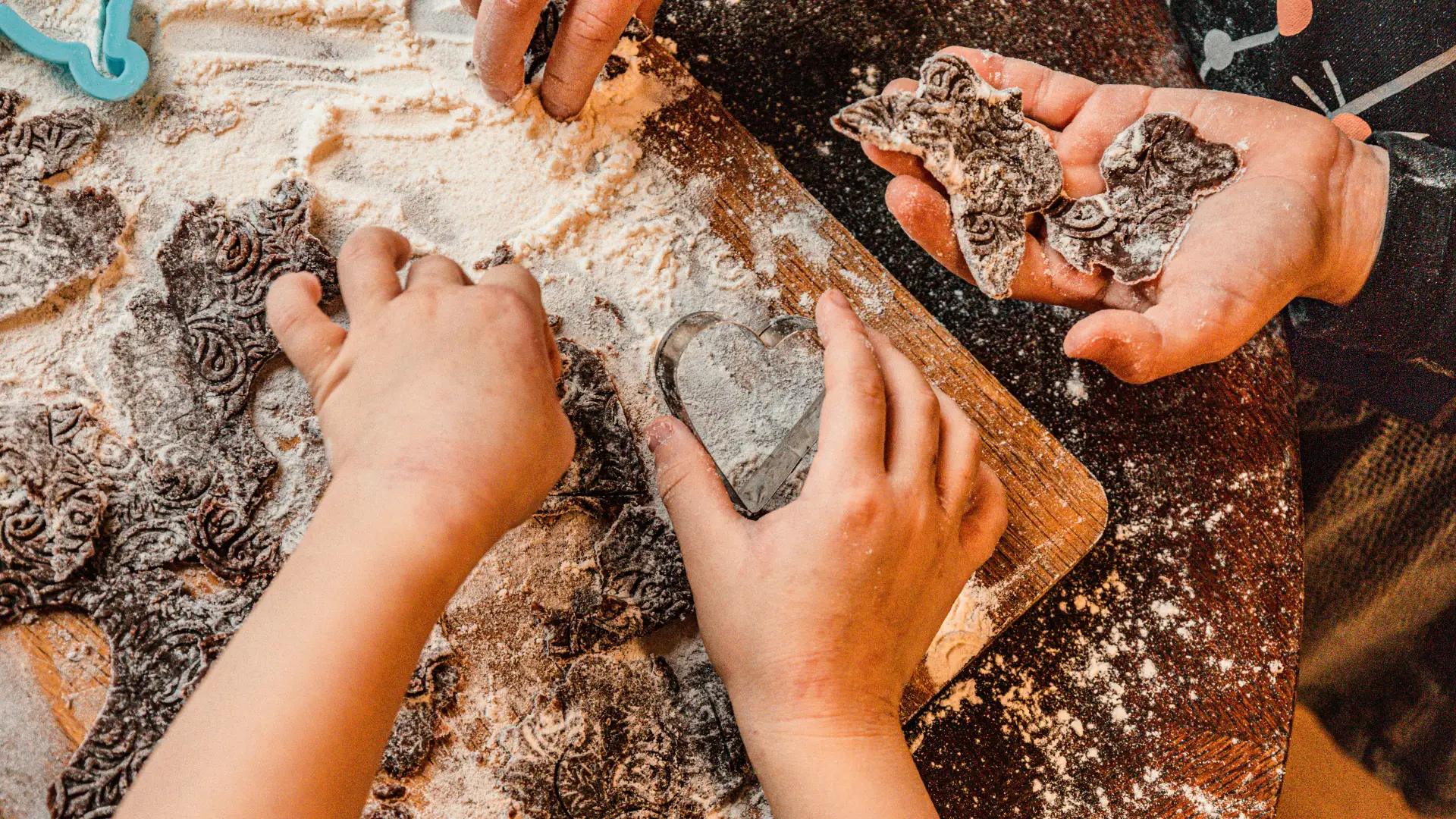 Kids hands playing with rocks and fossils in sand