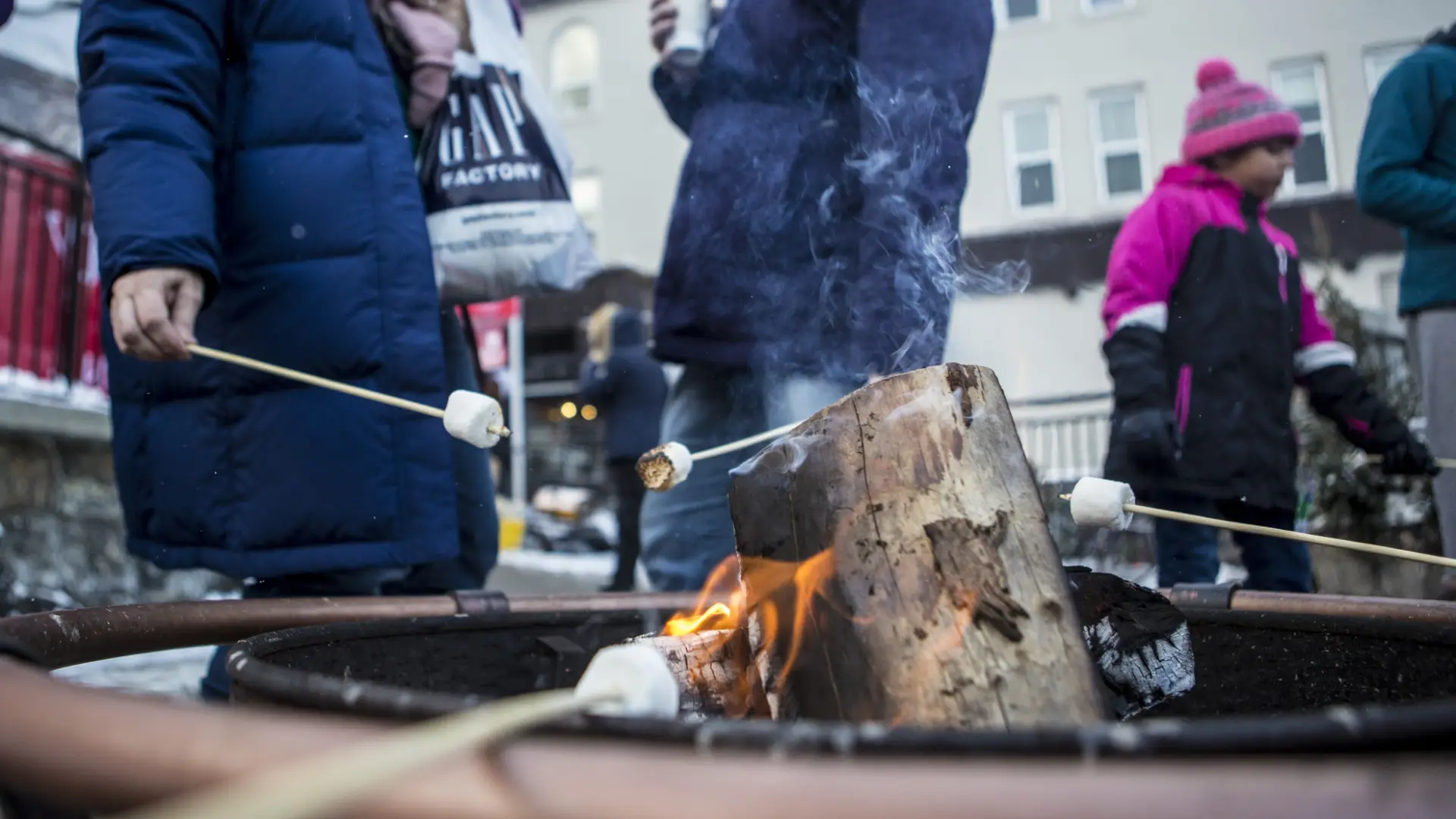 Close-up of roasting marshmallows on a firepit downtown.