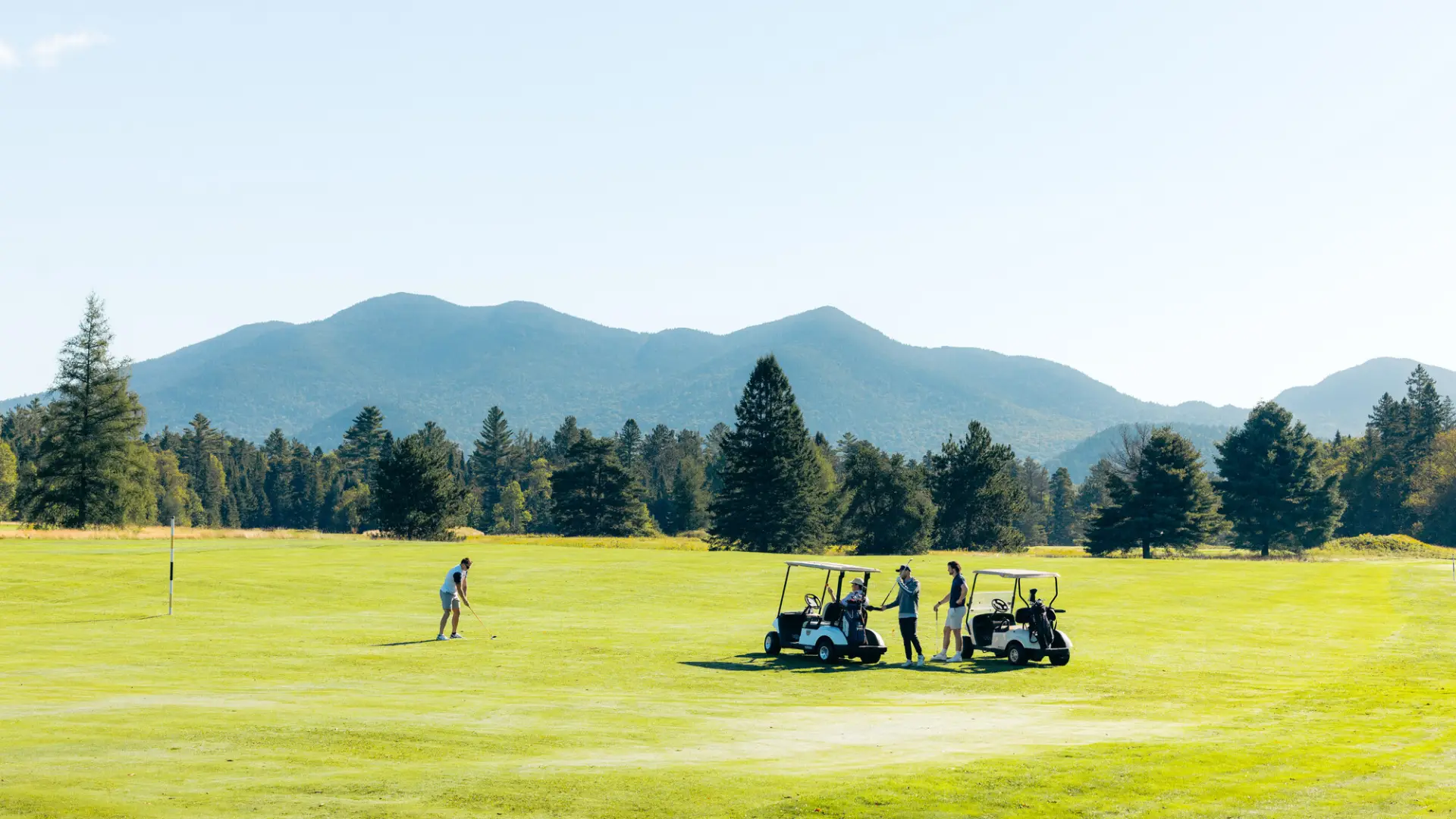A group of golfers standing on a Lake Placid golf course.