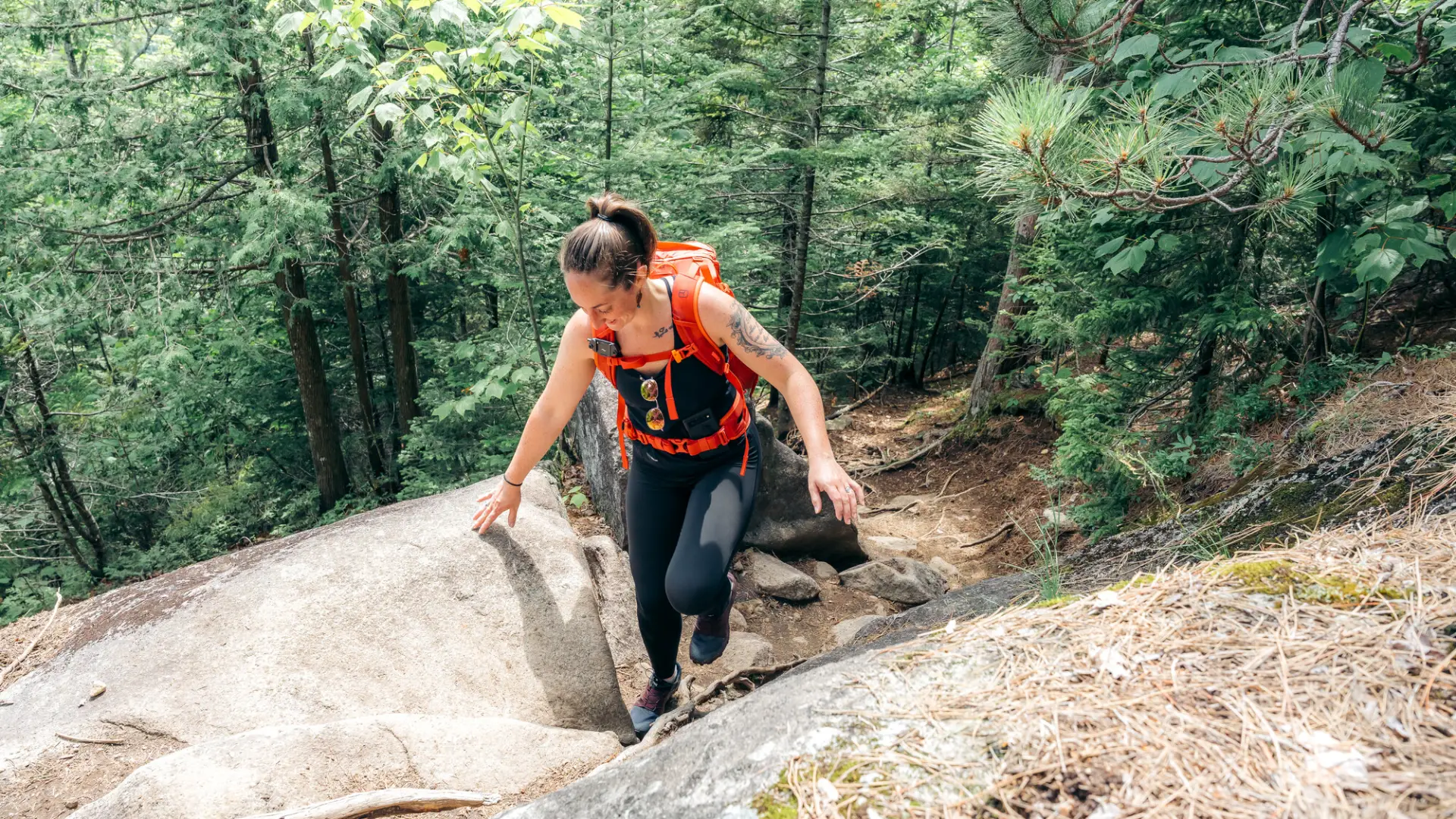Hiker walks up rocky section of trail