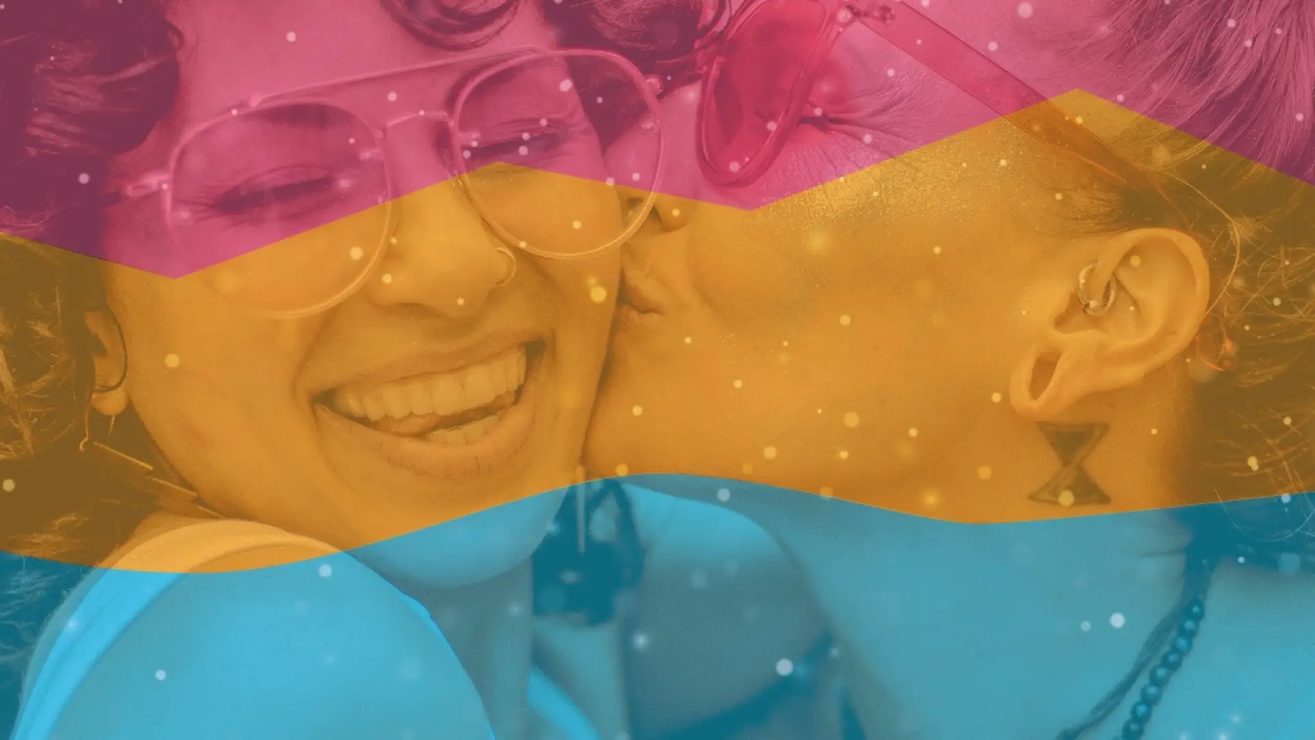 Pink, orange, and blue color waves overlaid over photo of woman kissing another woman's cheek while she smiles broadly