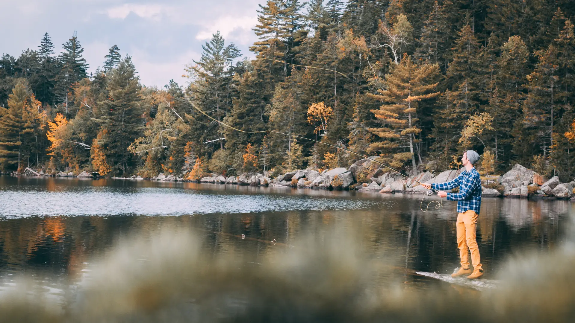 Fishing at a scenic pond in the fall