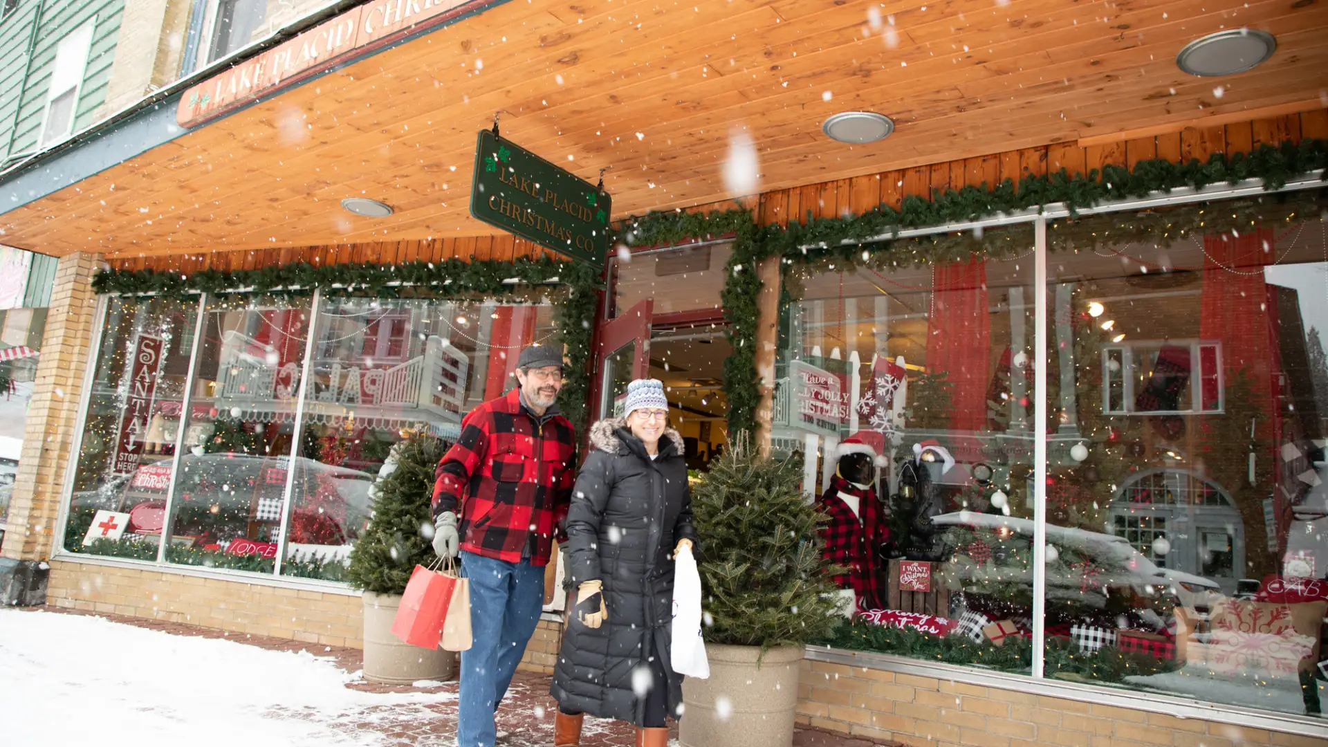 A man and woman shop Main Street on a snowy day.