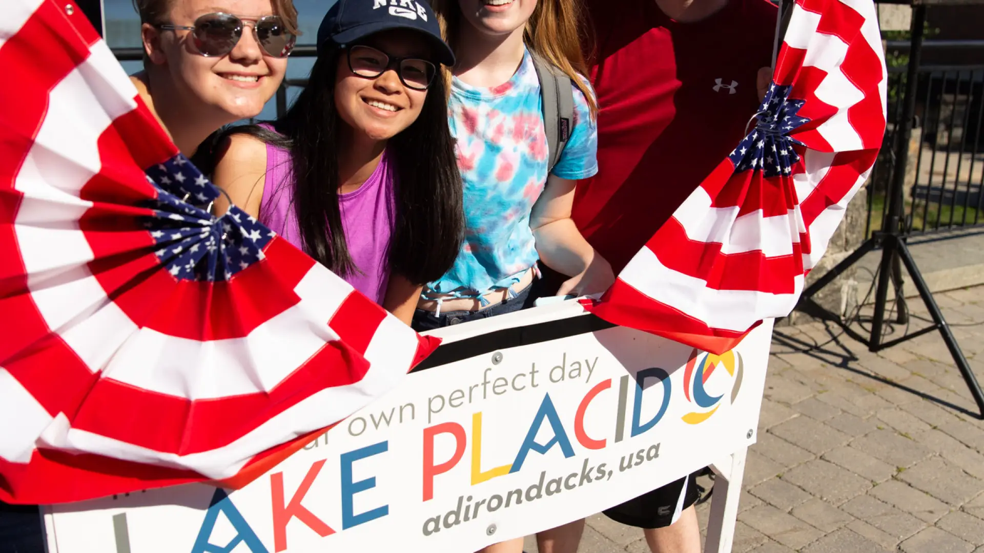 three teenagers pose for a photo in the Lake Placid selfie frame