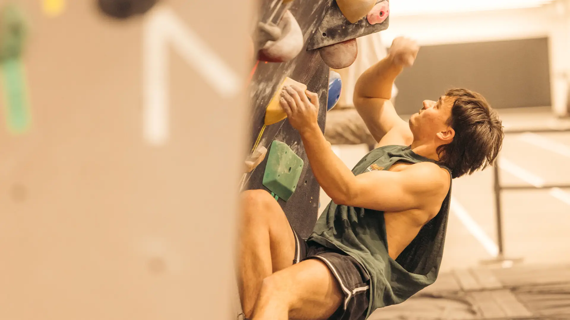 Person seen climbing on bouldering wall at Mt Van Hoevenberg indoor climbing gym