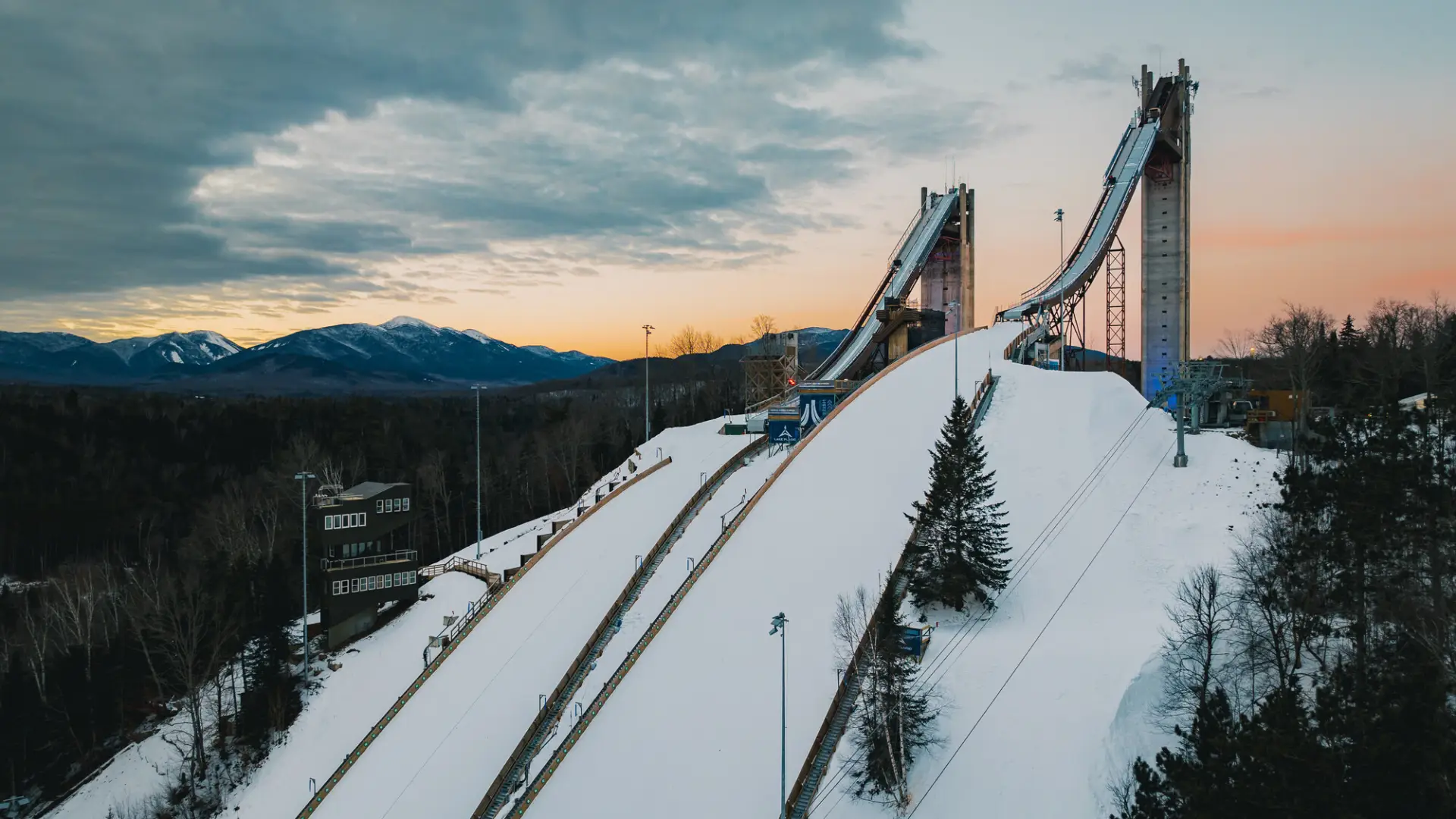 Two olympic ski jumps in the snow.
