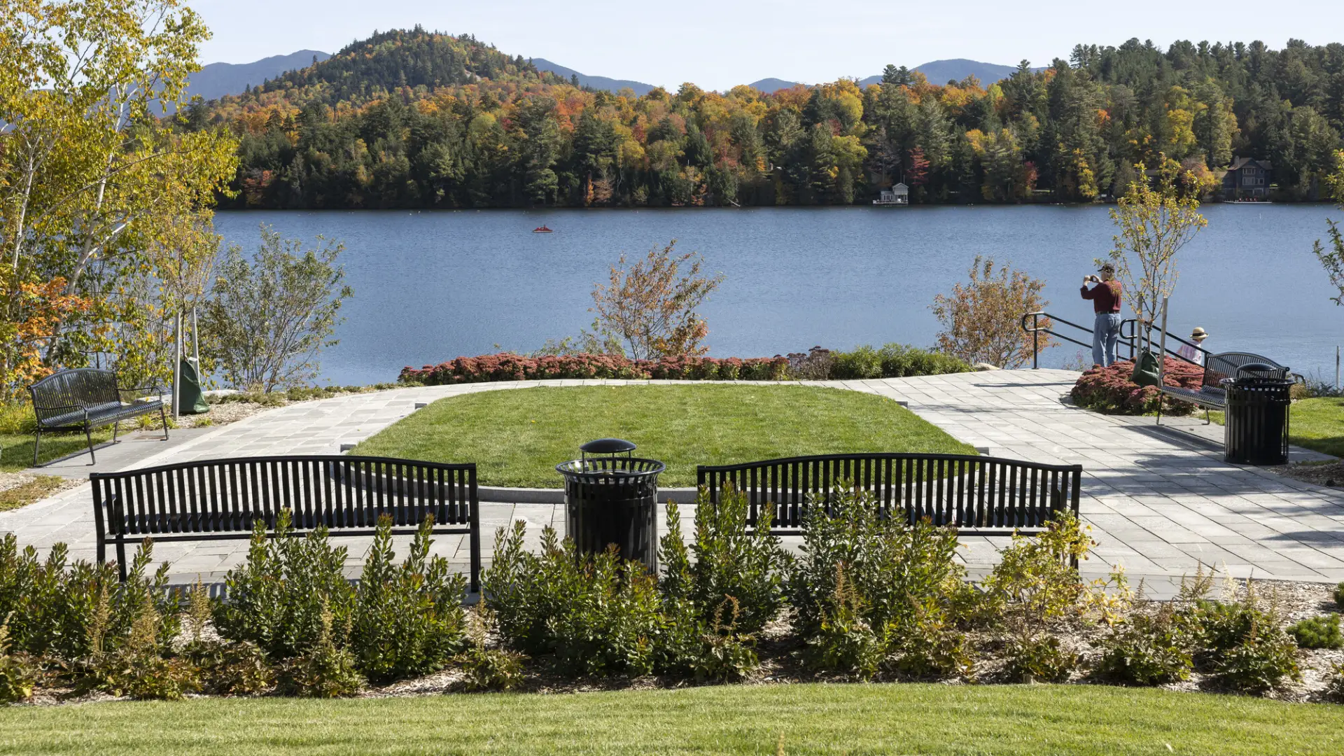 Park benches and green space at the edge of a lake