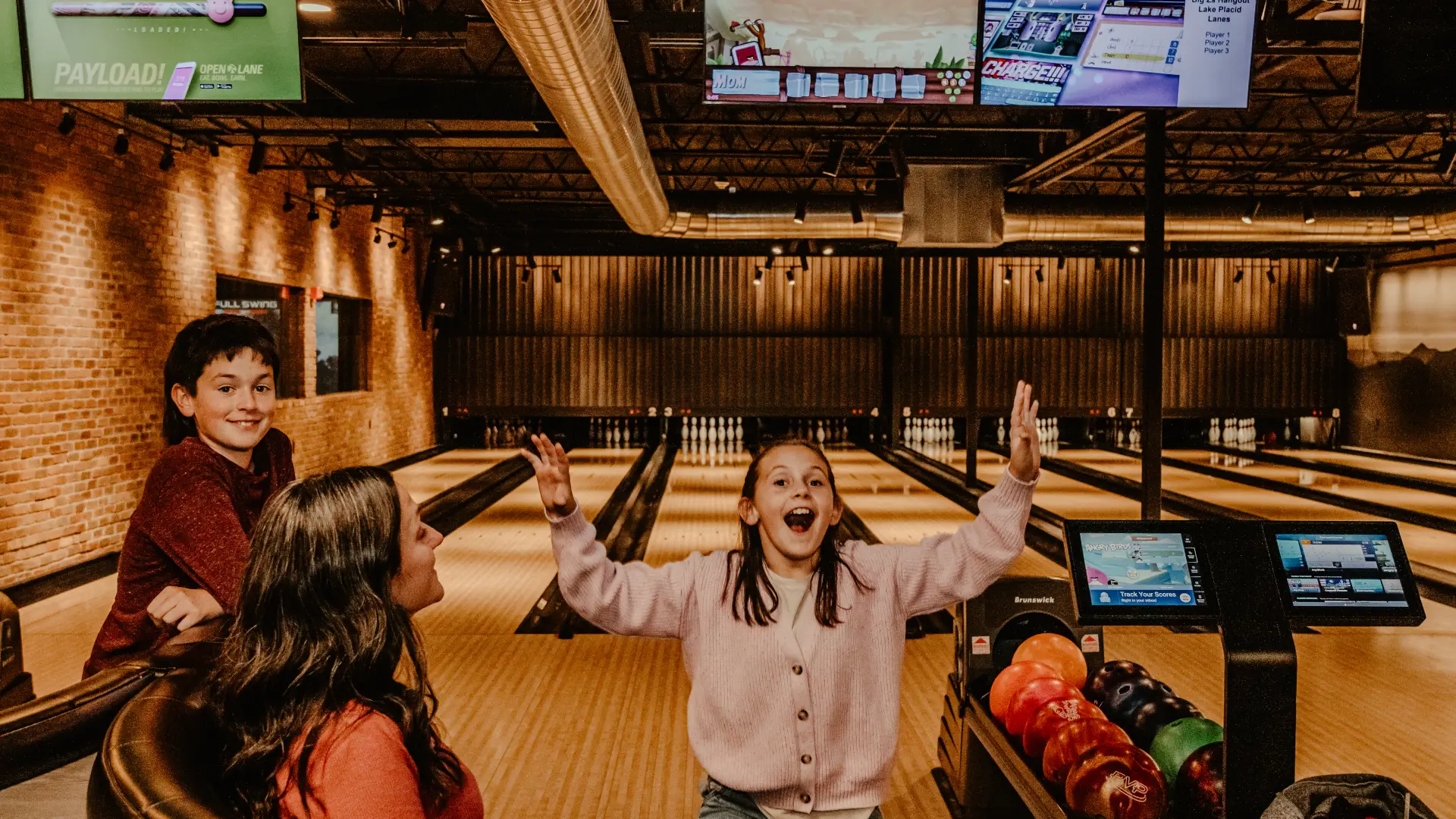 A young family is very excited to bowl.  Photo Credit to A. Kelly.