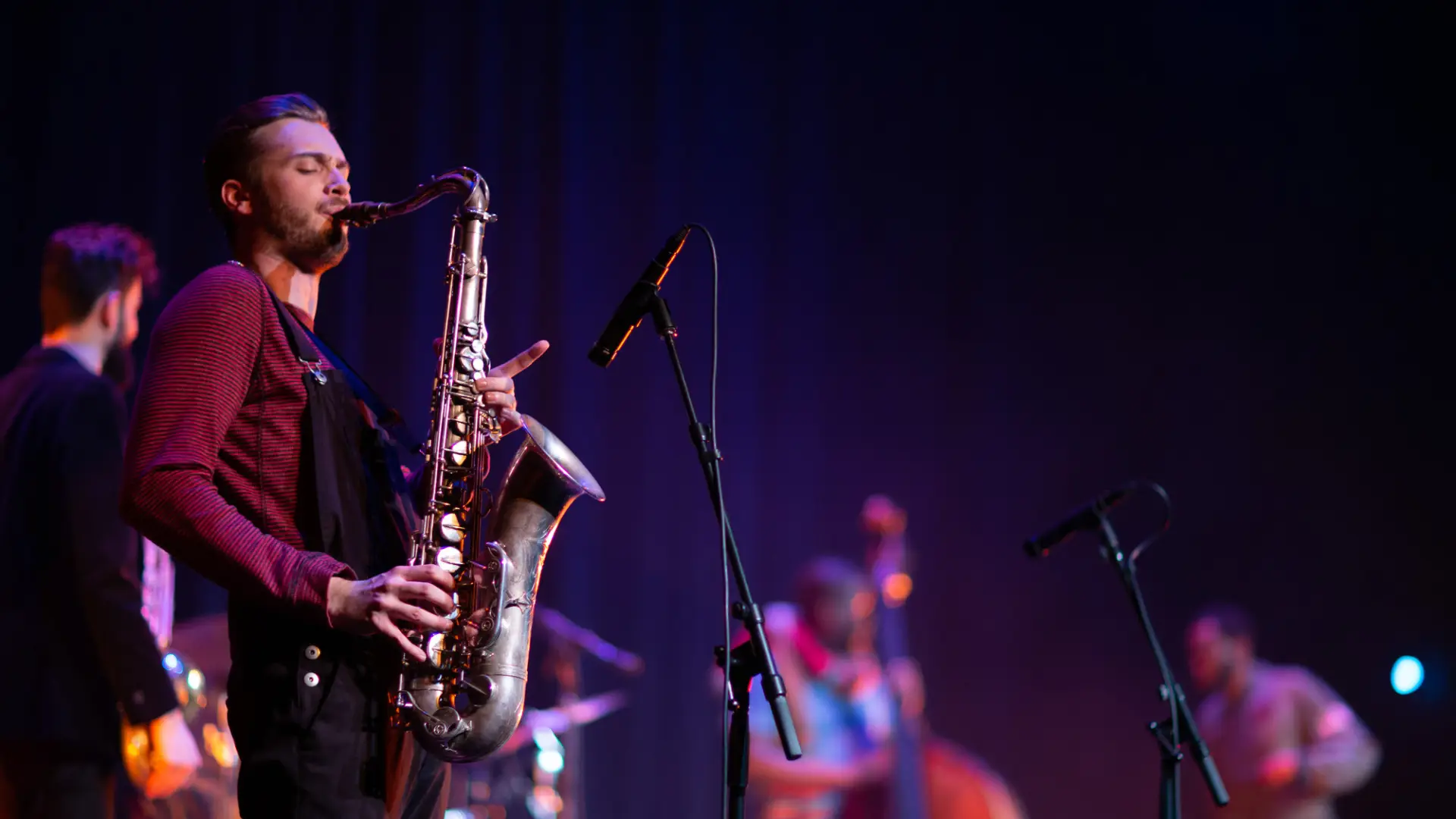 A saxophone player playing in a live band.