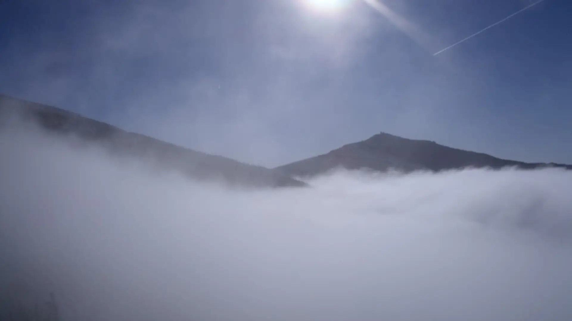 A wonderful shot of low clouds draping the peaks.