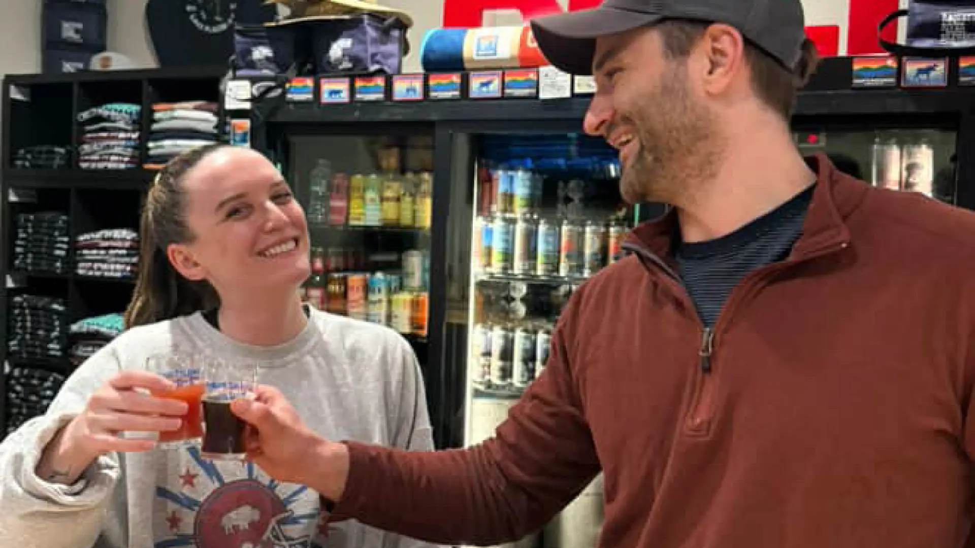 Two patrons enjoying a tasting flight of beers