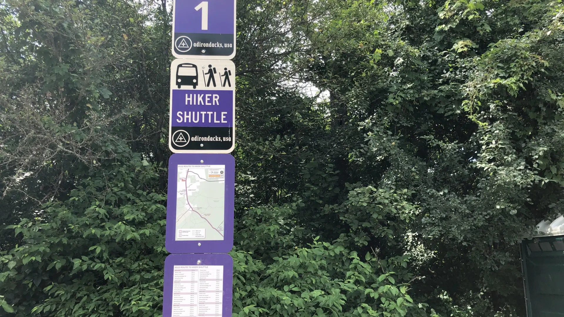 The hiking shuttle signs at Marcy Field