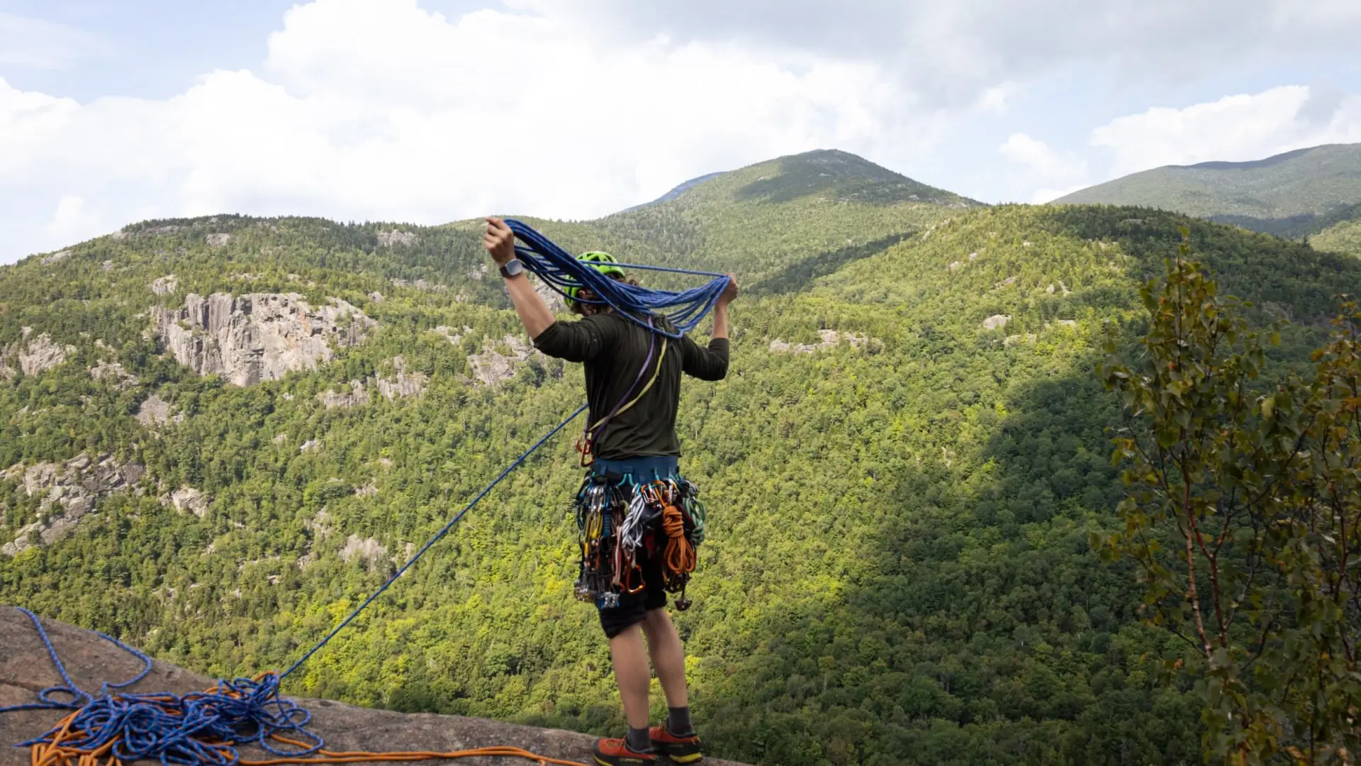Man nests ropes to prepare for rock climbing