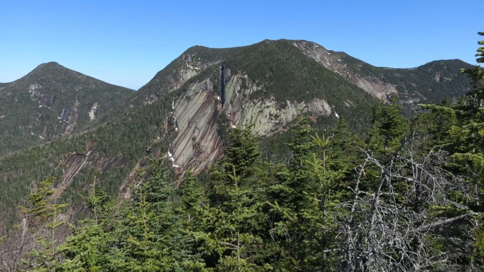 A closer look at Sawteeth's peak from another mountain.