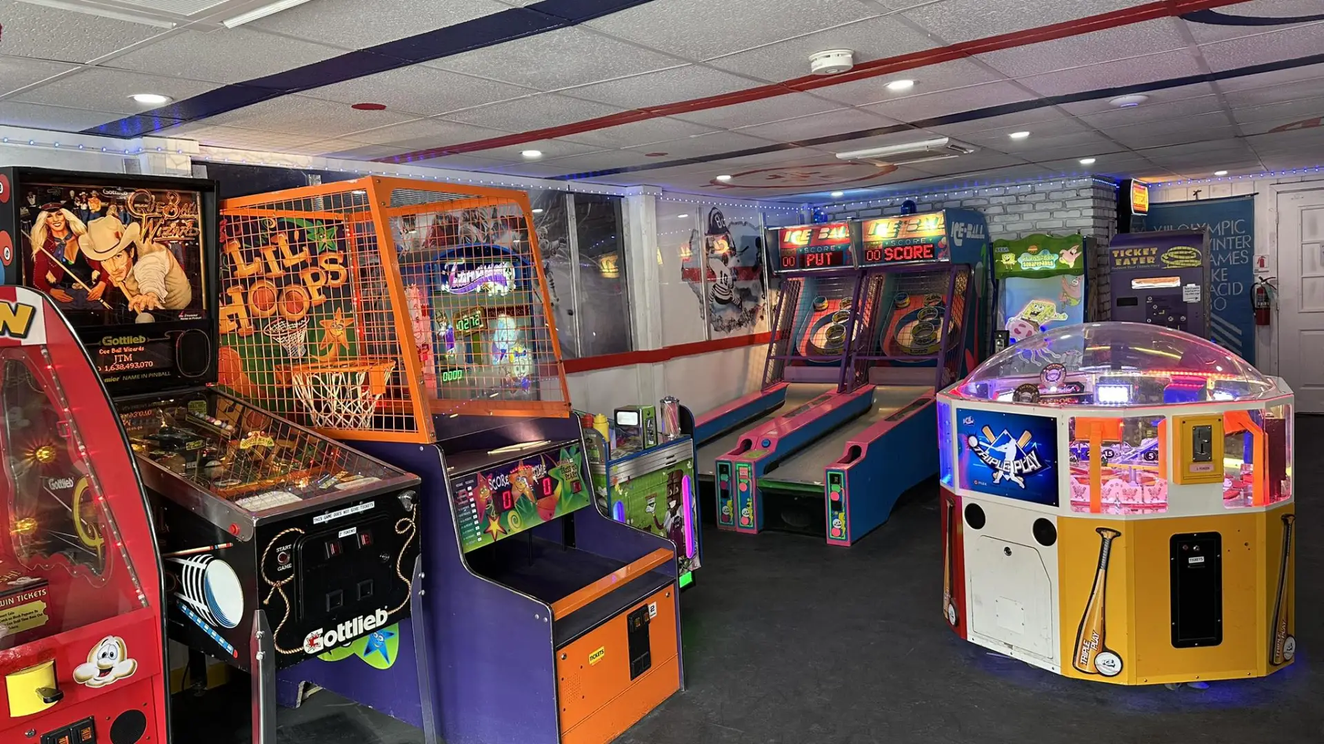 View of various arcade games in an interior room at The Penalty Box Arcade