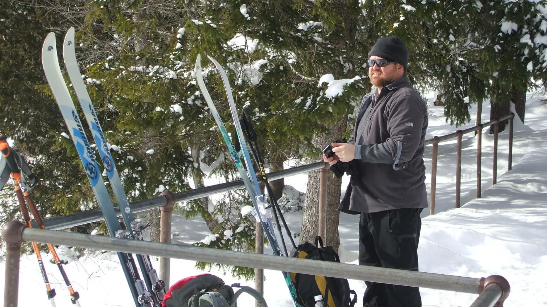 A man with cross-country skis at Marcy Dam
