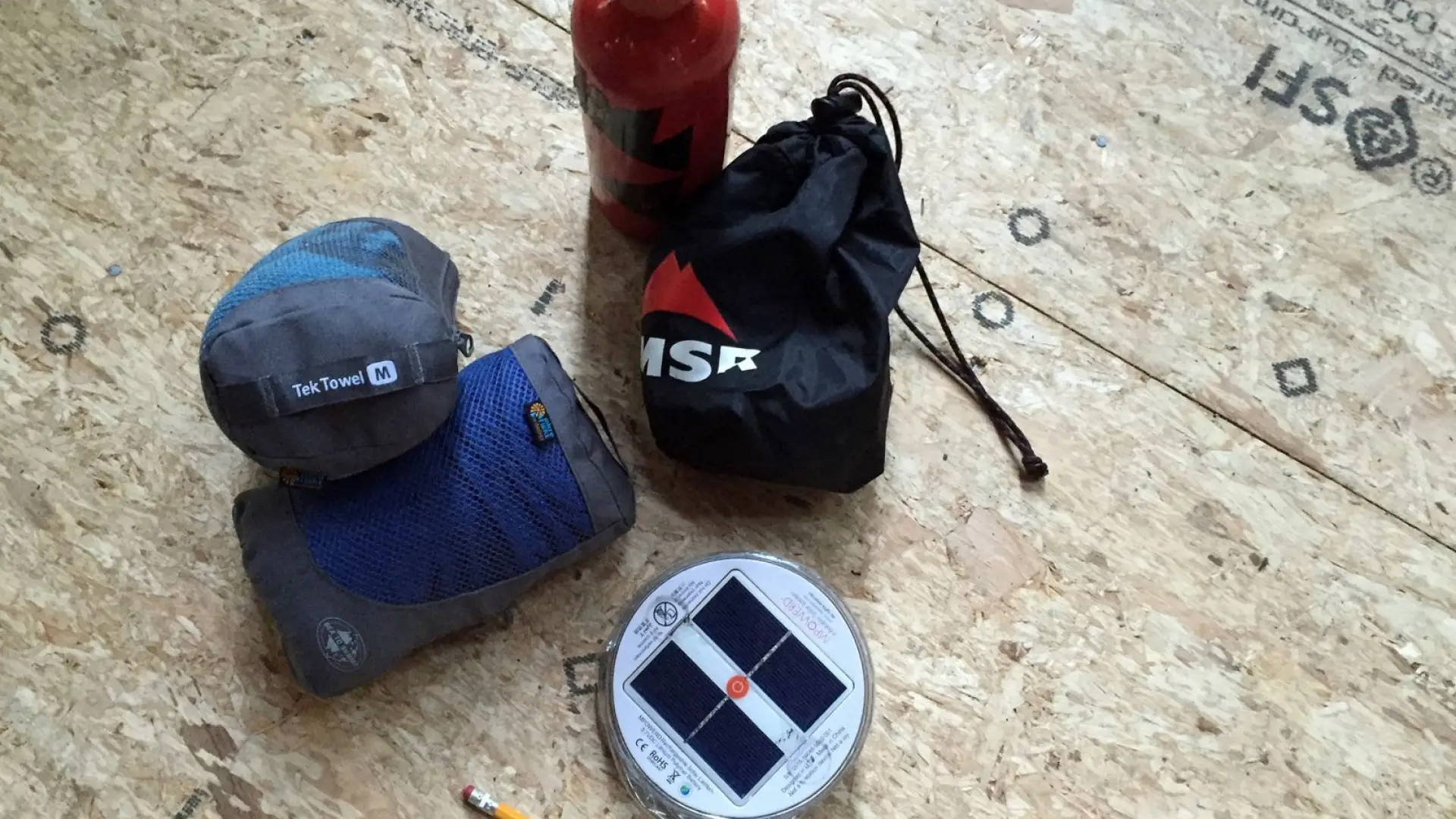 Stove, towels and lantern, with a pencil for scale.