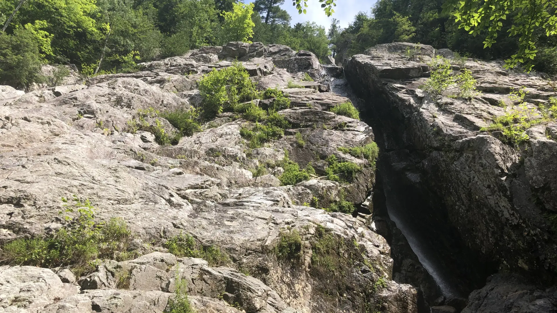 The rocky side of the falls on a sunny day