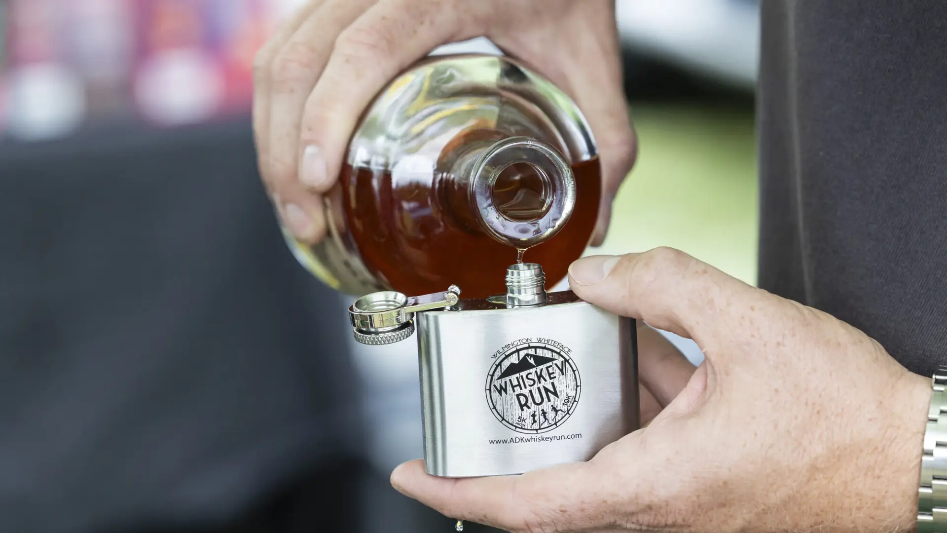 Whiskey pouring into flask