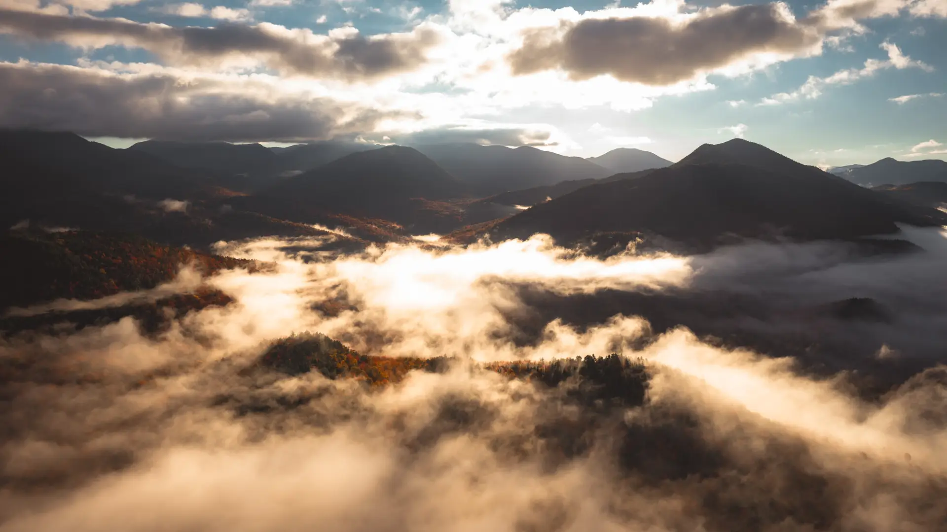 Misty mountains in the fall, seen from the sky