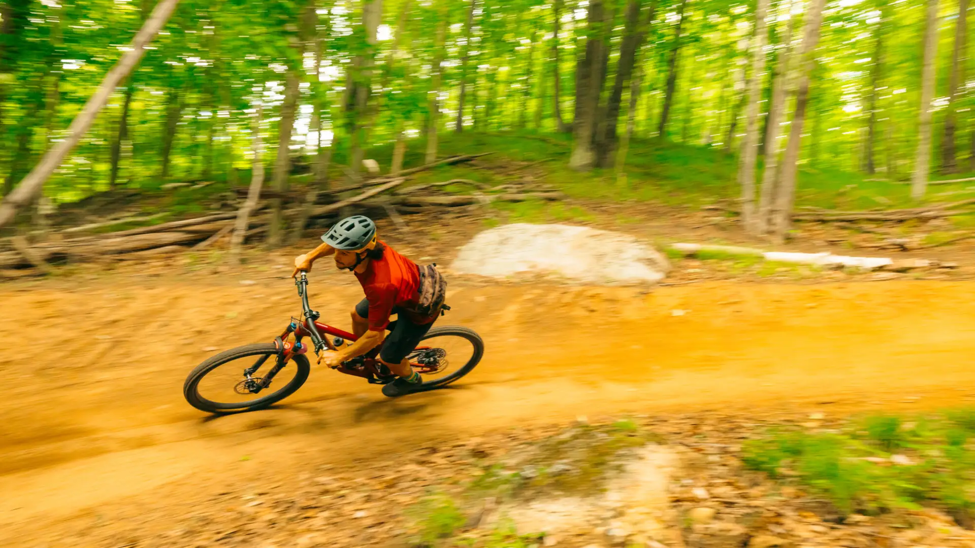A mountain biker going around a berm