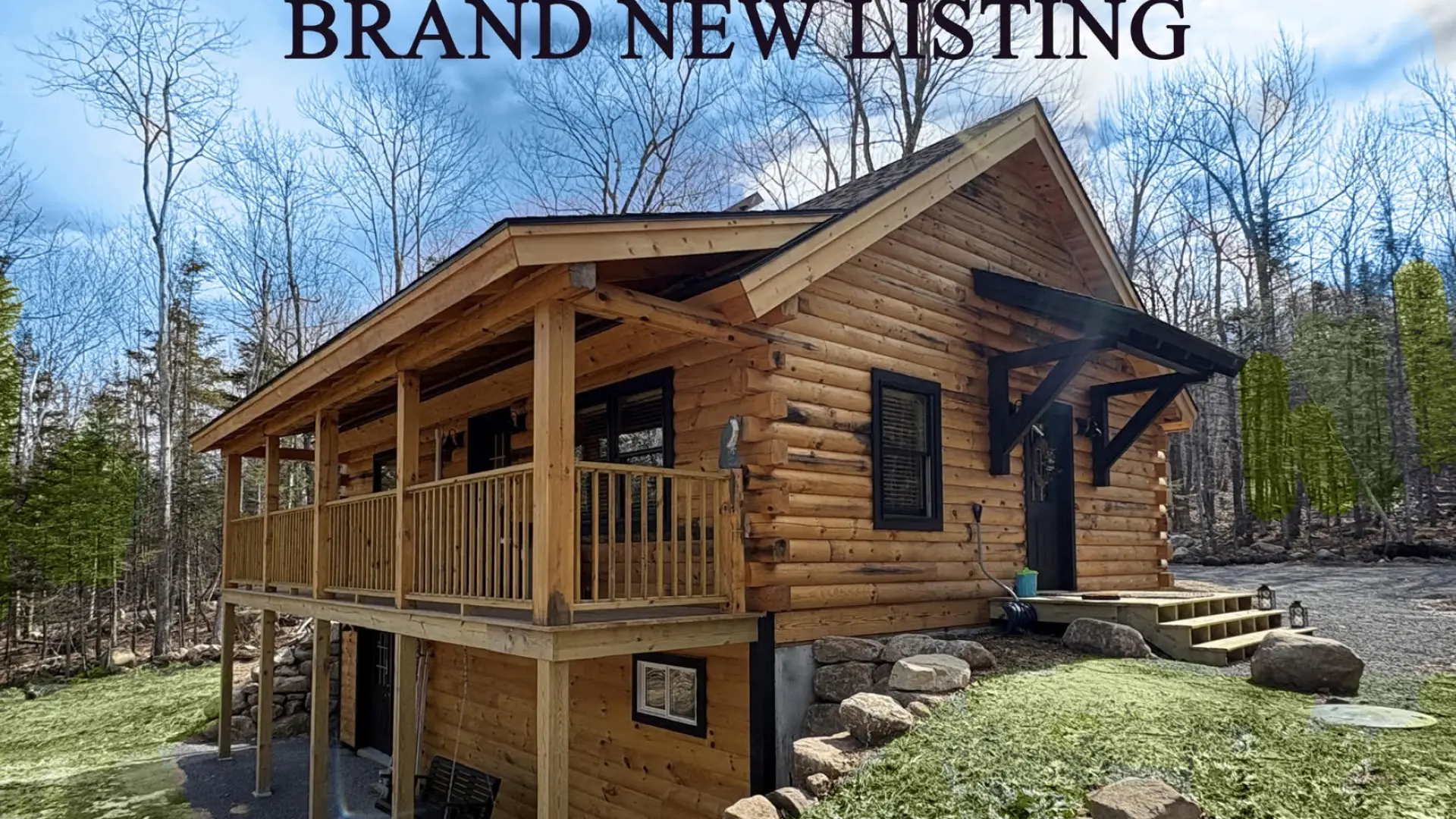 Log cabin on a hillside with lush greenery and the title Brand New Listing.