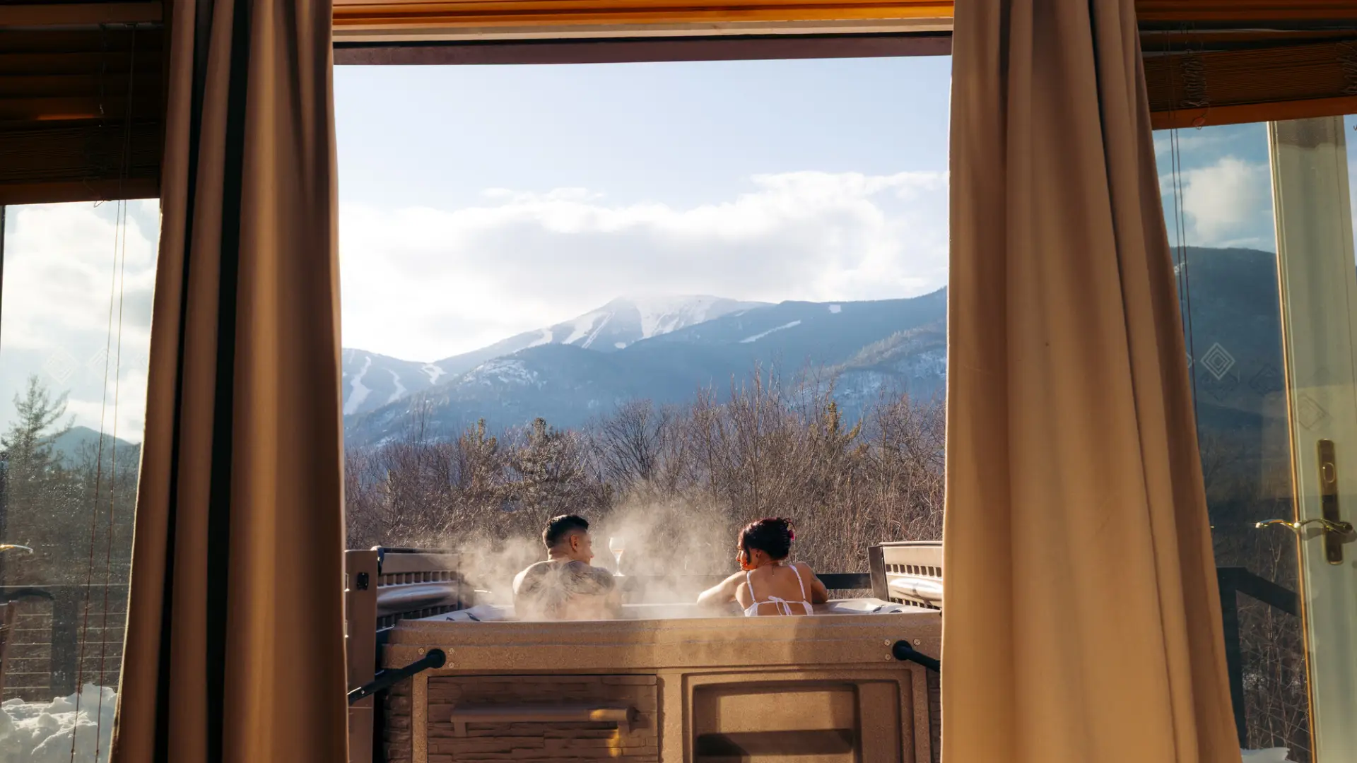 A man and woman relax in a hot tub.