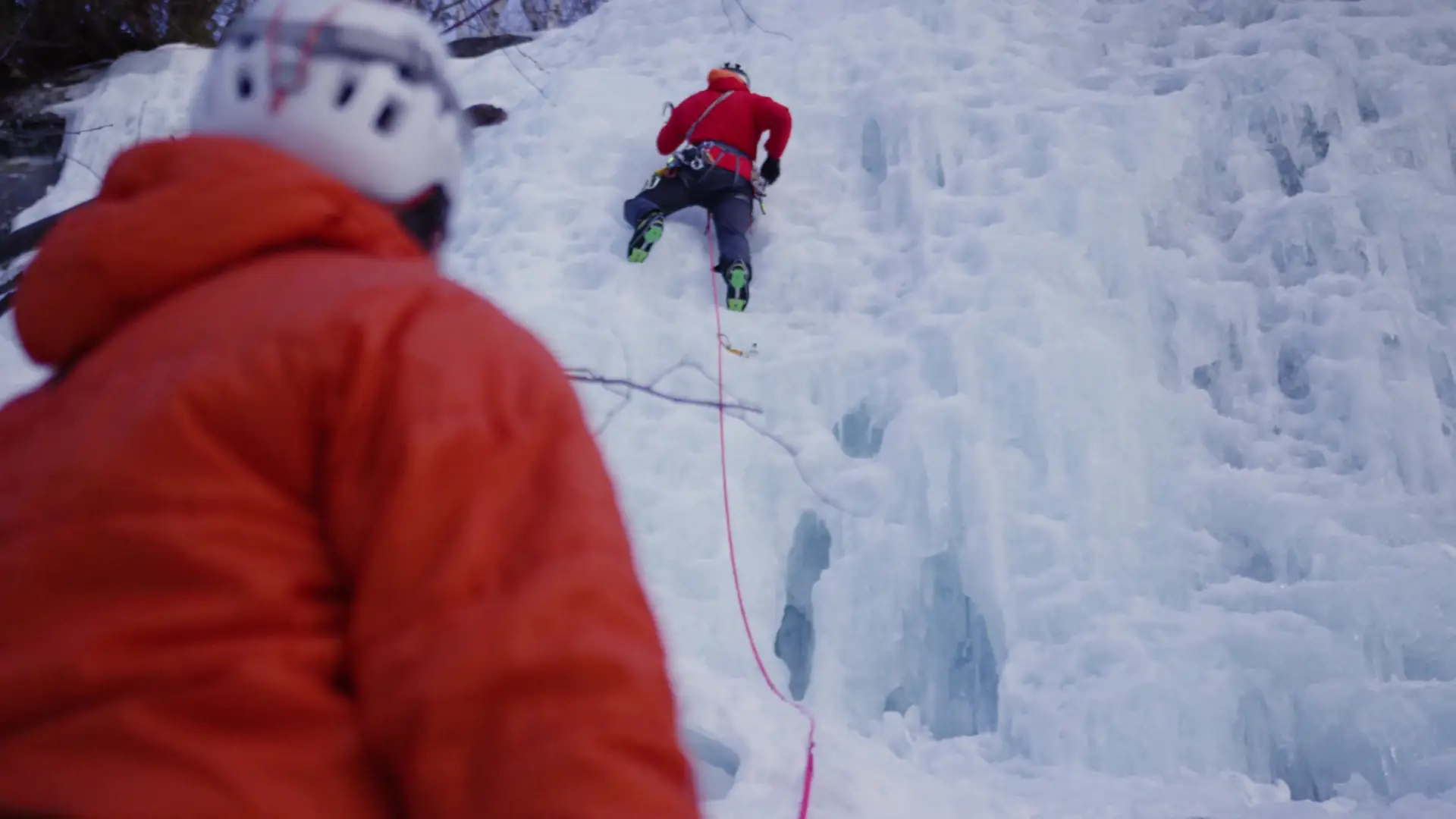 A person belaying an ice climber