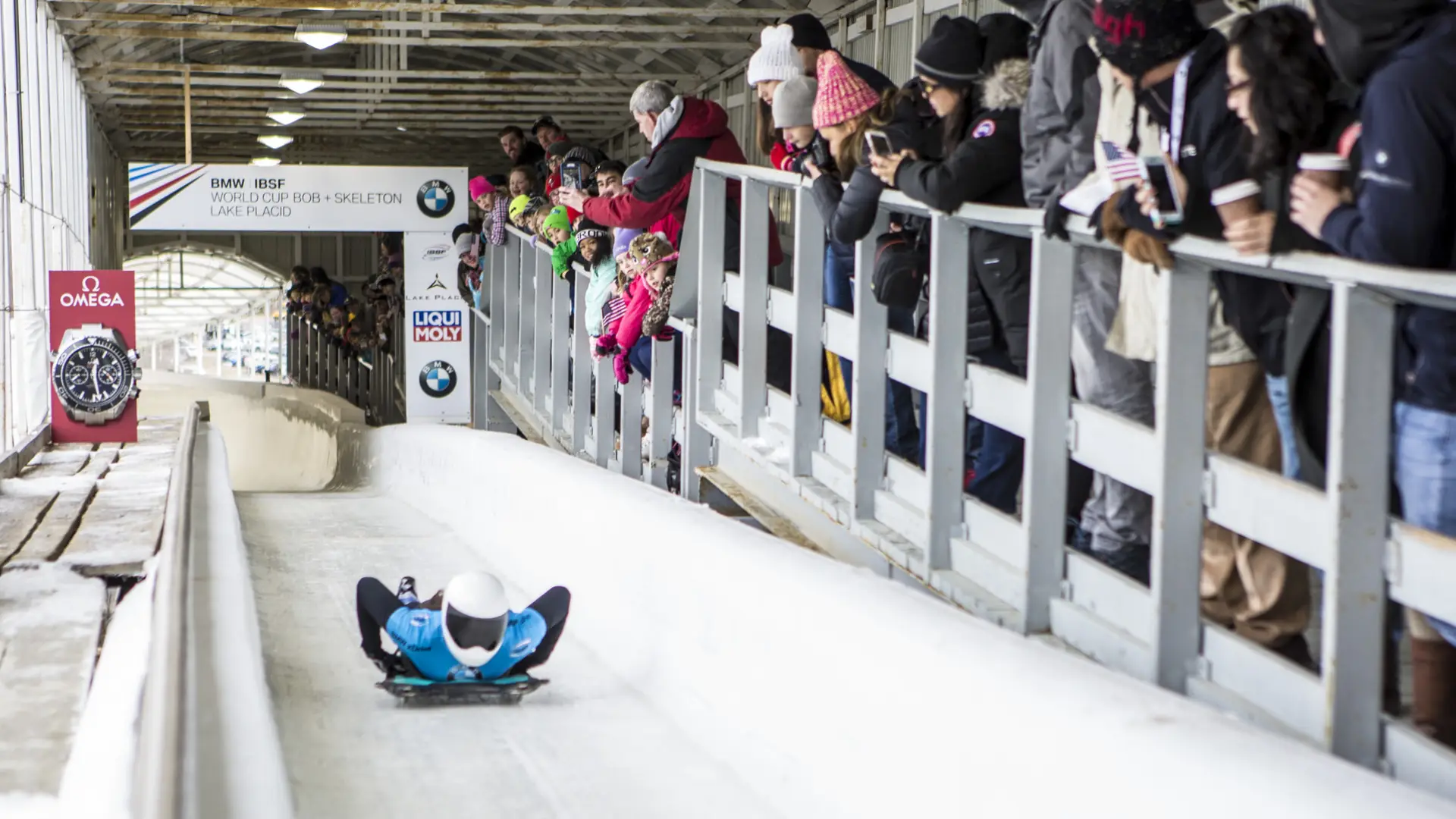 Fans spectate a skeleton sliding event