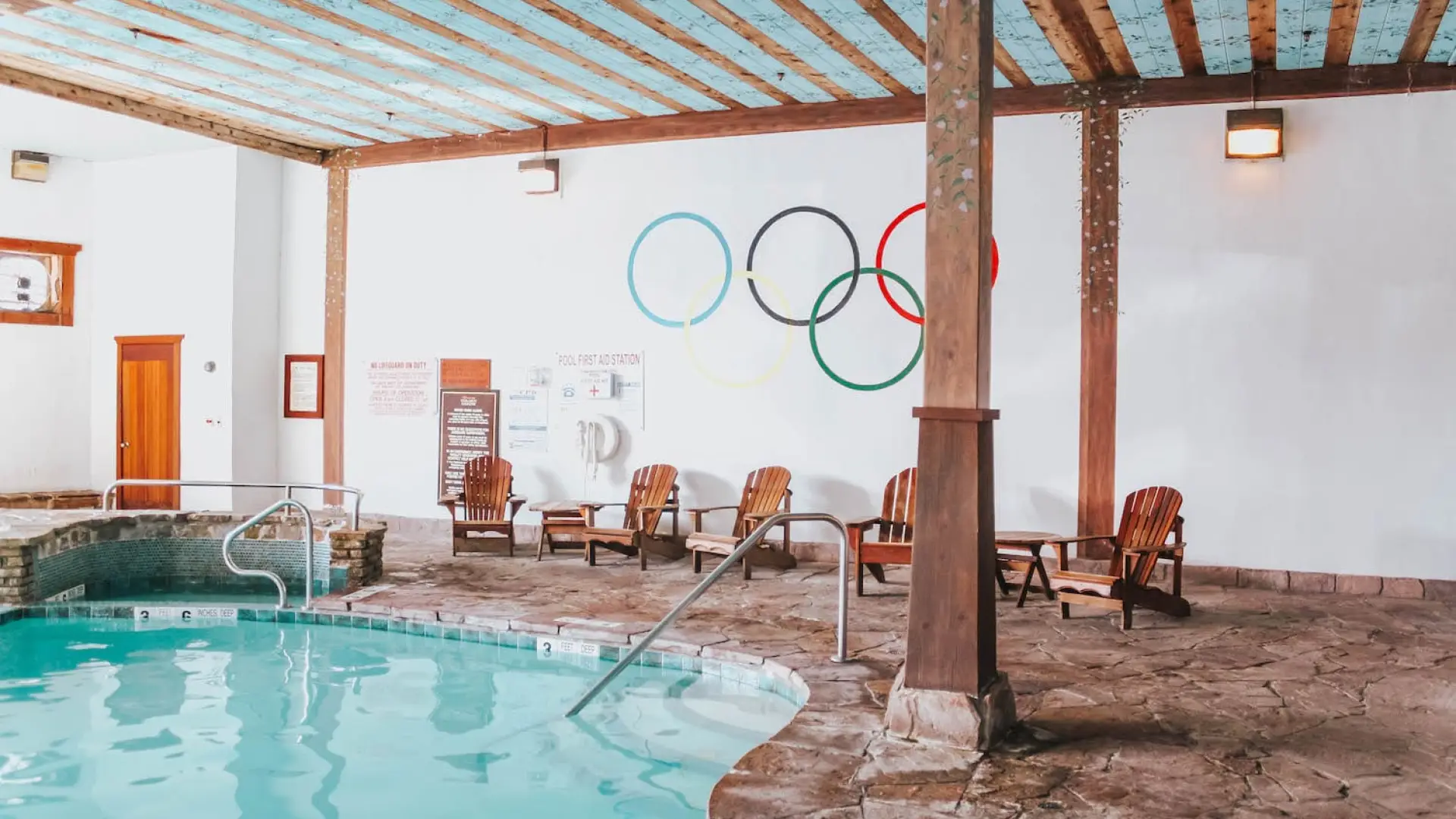 The Olympic Rings adorn the wall above the indoor swimming pool at the Golden Arrow Lakeside Resort