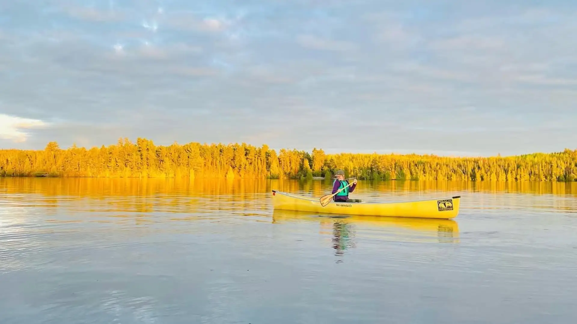A woman paddling a canoe.