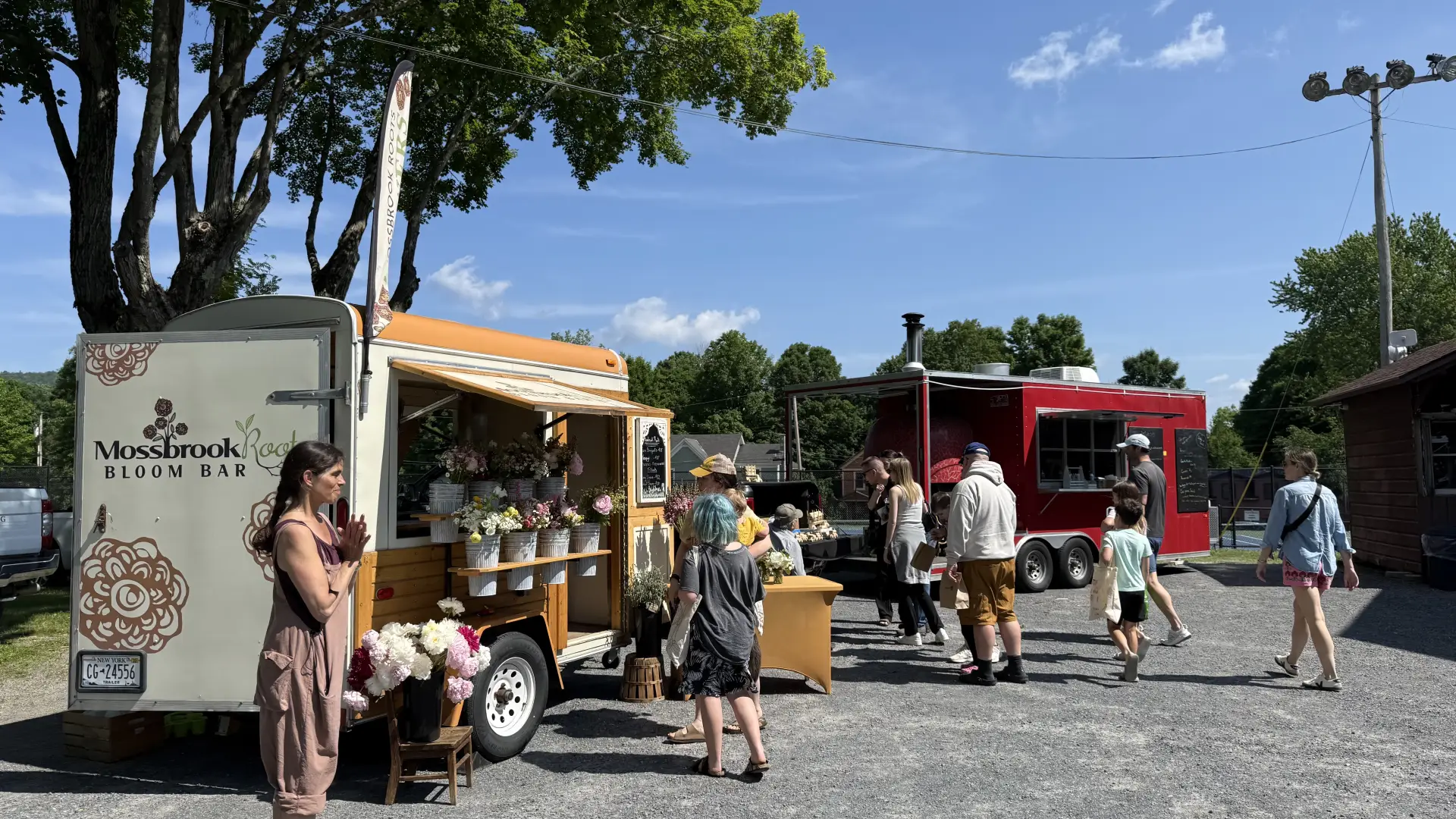 A traveling flower stand called the Mossbrook Bloom Bar is designed to showcase all the beautiful flowers grown on the farm with shelves modified to hold galvanized water buckets filled with peonies