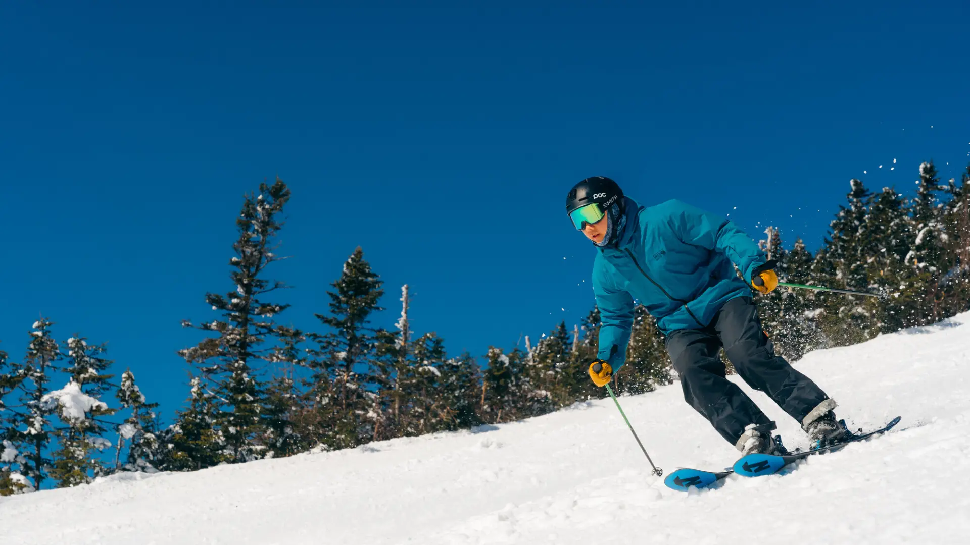 A skier races down a powdery mountain. 