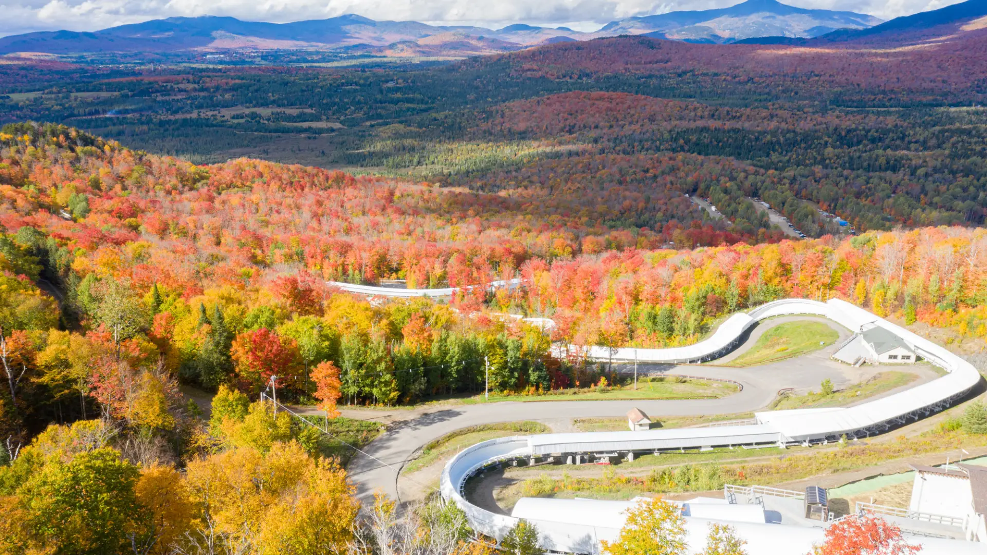 the white bobsled course stands out amongst the vibrant fall foliage