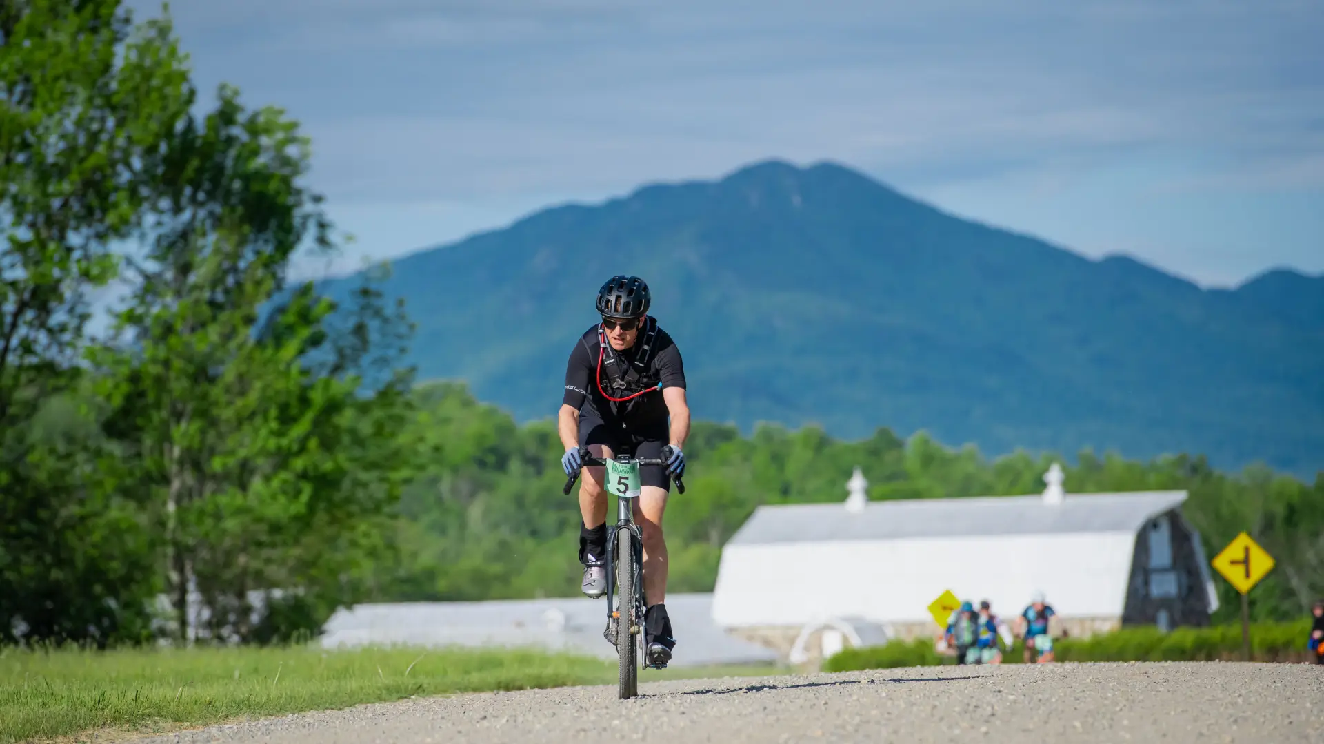 Bike racer on road with mountain in background